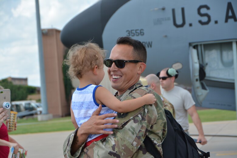 U.S. Air Force Tech. Sgt. Joey Onco, KC-135R Stratotanker aircraft crew chief with the 507th Aircraft Maintenance Squadron at Tinker Air Force Base, Okla., hugs his son following a deployment July 5, 2018. More than 100 Reserve Citizen Airmen from the 507th Air Refueling Wing at Tinker AFB deployed to Incirlik Air Base, Turkey, in support of air operations. (U.S. Air Force photo by Tech. Sgt. Samantha Mathison)