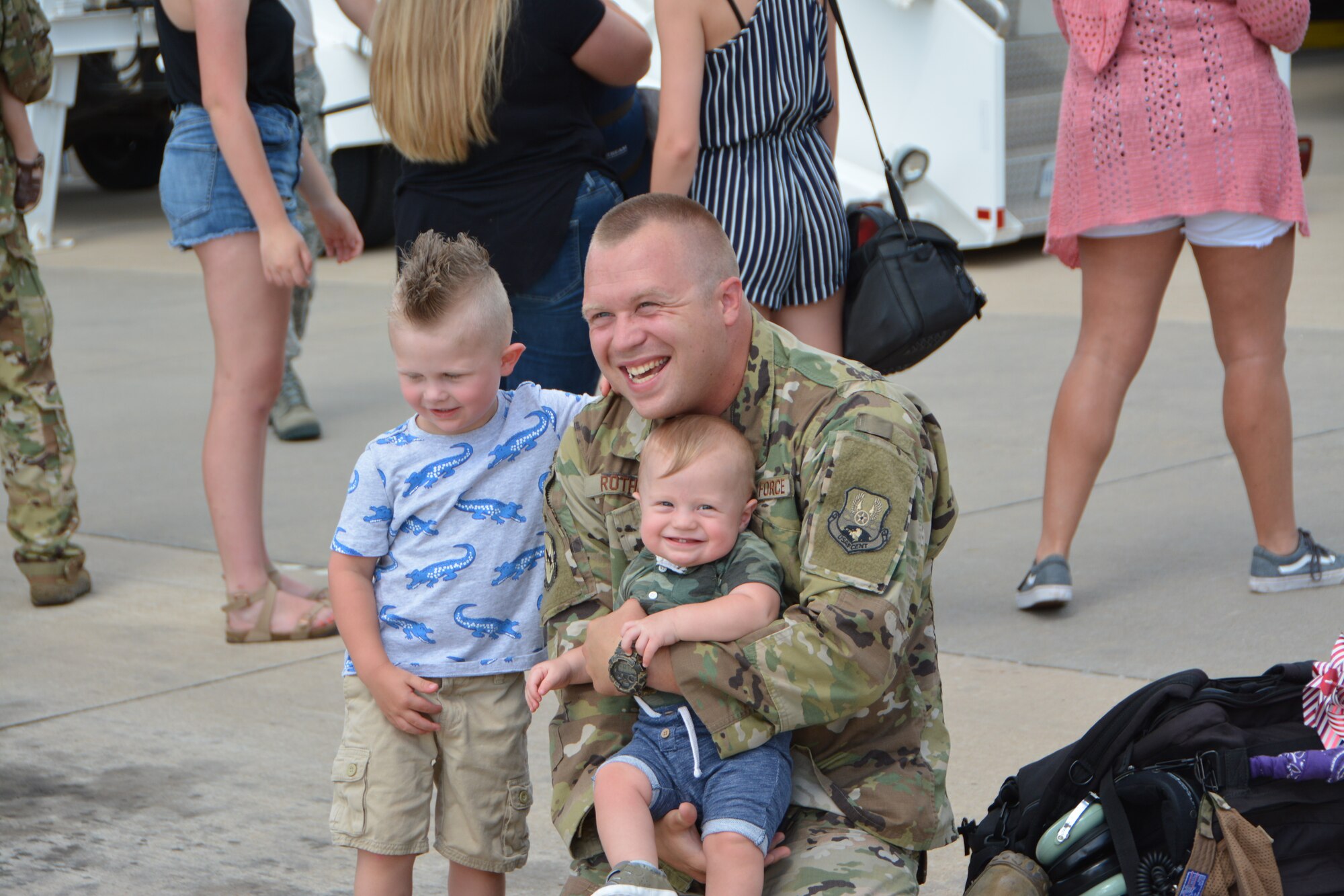 U.S. Air Force Master Sgt. Landon Rother, a KC-135R Stratotanker aircraft avionics technician with the 507th Aircraft Maintenance Squadron at Tinker Air Force Base, Okla., reunites with his family following a deployment July 5, 2018. More than 100 Reserve Citizen Airmen from the 507th Air Refueling Wing at Tinker AFB deployed to Incirlik Air Base, Turkey, in support of air operations. (U.S. Air Force photo by Tech. Sgt. Samantha Mathison)