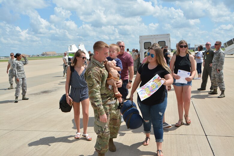 U.S. Air Force Staff Sgt. Joshua Hines, a KC-135R Stratotanker aircraft crew chief with the 507th Aircraft Maintenance Squadron at Tinker Air Force Base, Okla., greets his family following a deployment July 5, 2018. More than 100 Reserve Citizen Airmen from the 507th Air Refueling Wing at Tinker AFB deployed to Incirlik Air Base, Turkey, in support of air operations. (U.S. Air Force photo by Tech. Sgt. Samantha Mathison)