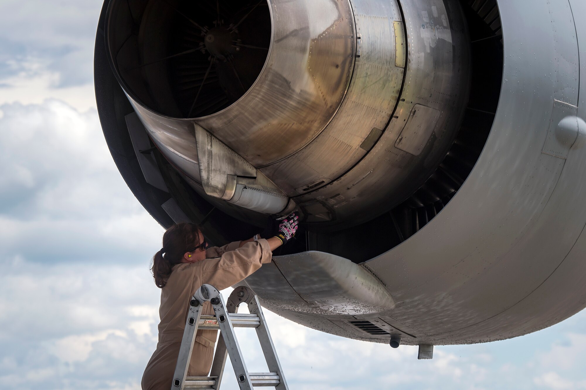 Master Sgt. Angelia Gholson, 164th Aircraft Maintenance Squadron flying crew chief, Memphis Air National Guard Base, TN, inspects the engine of a C-17 Globemaster III, July 5, 2018, at Moody Air Force Base, Ga. Airmen loaded approximately 68,000 pounds of cargo onto a C-17 Globemaster III to aid the 75th Fighter Squadron (FS) prior to a deployment. The 75th FS and supporting units recently deployed to an undisclosed location in support of Operation Spartan Shield. (U.S. Air Force photo by Airman 1st Class Eugene Oliver)
