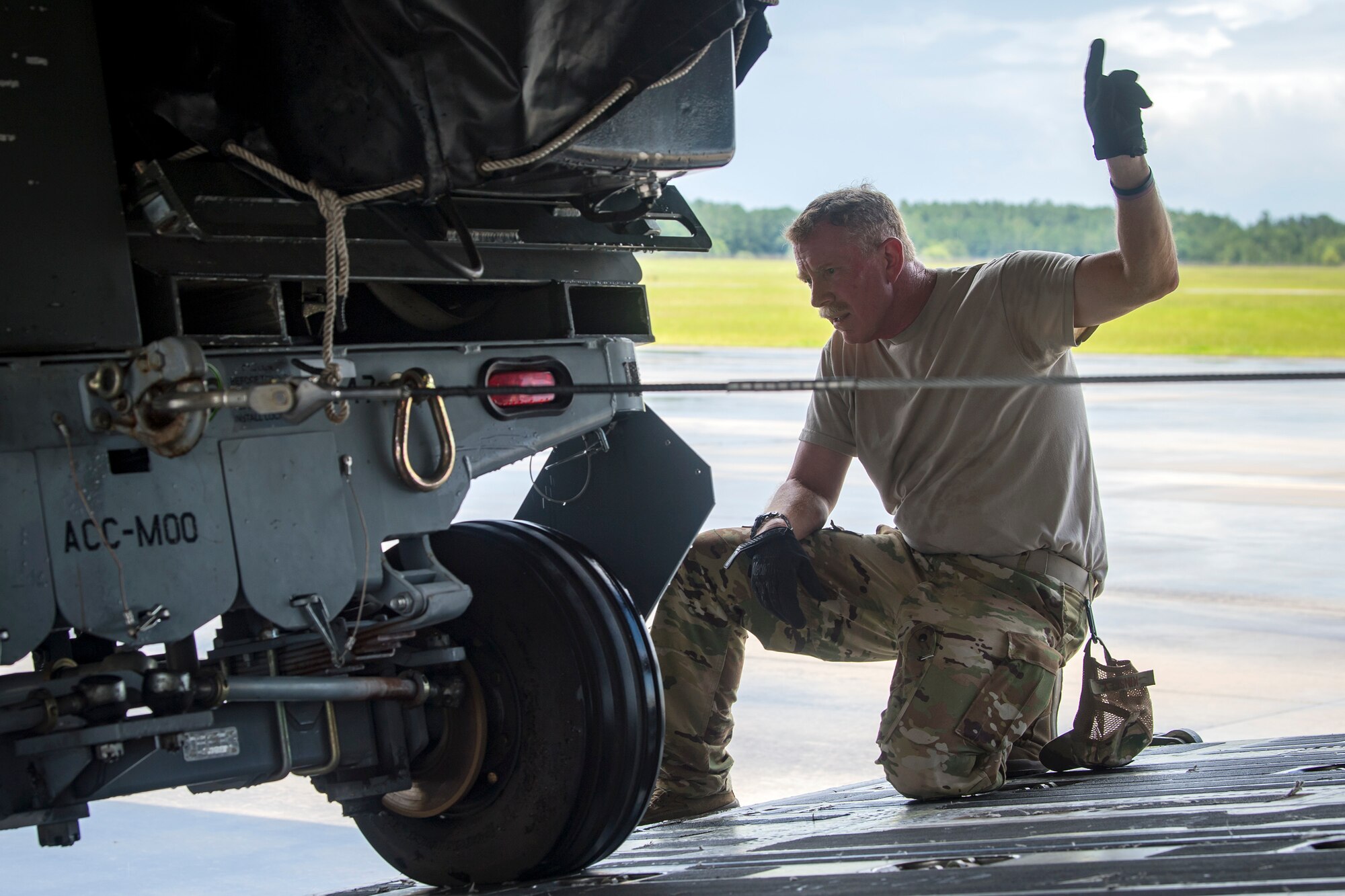 Master Sgt. Robert Kinsley, 155th Airlift Squadron loadmaster, Memphis Air National Guard Base, TN, signals to move cargo, July 5, 2018, at Moody Air Force Base, Ga. Airmen loaded approximately 68,000 pounds of cargo onto a C-17 Globemaster III to aid the 75th Fighter Squadron (FS) prior to a deployment. The 75th FS and supporting units recently deployed to an undisclosed location in support of Operation Spartan Shield. (U.S. Air Force photo by Airman 1st Class Eugene Oliver)