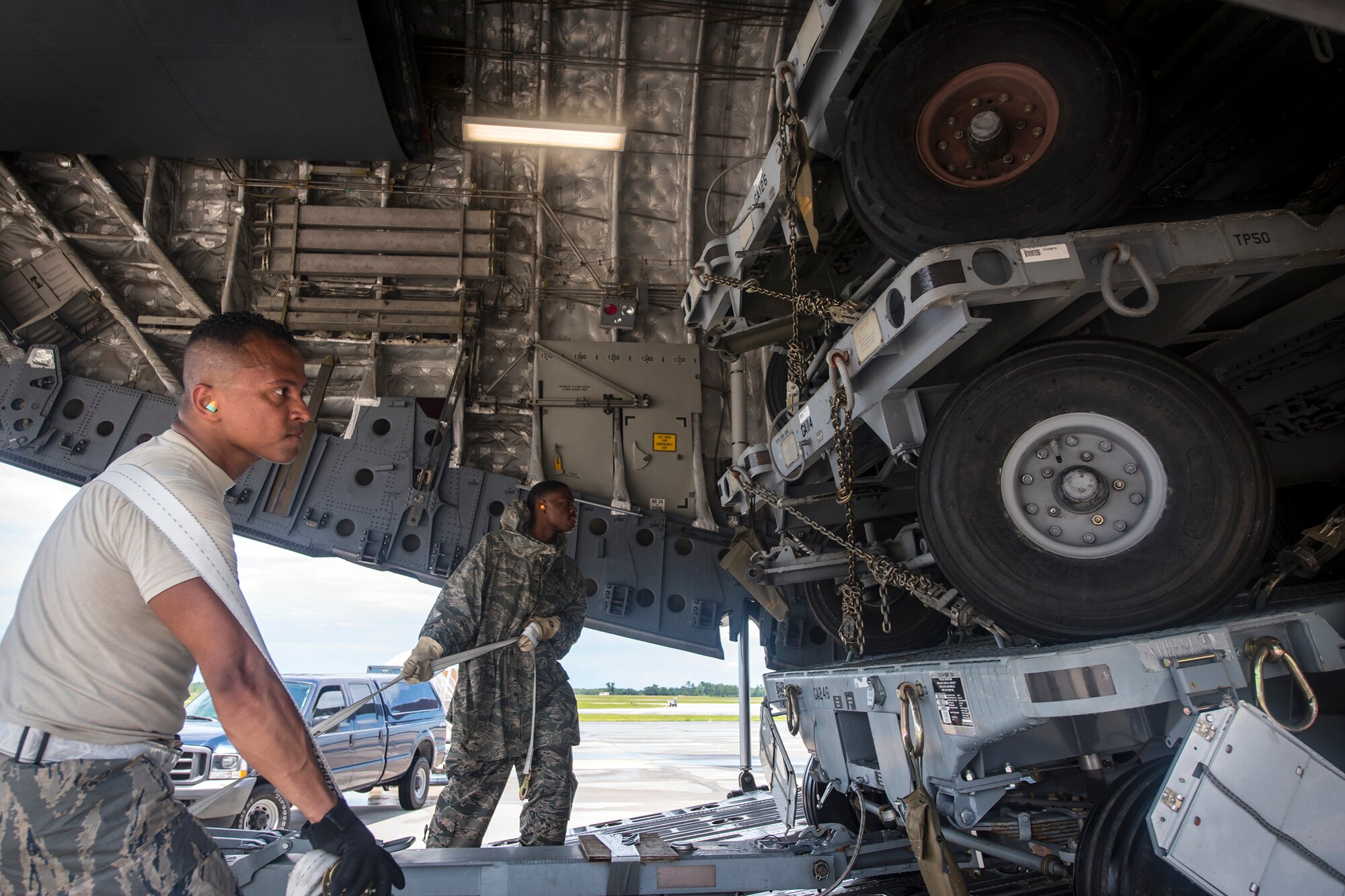 Airmen from the 23d Logistics Readiness Squadron guide cargo up the ramp of a C-17 Globemaster III, July 5, 2018, at Moody Air Force Base, Ga. Airmen loaded approximately 68,000 pounds of cargo onto a C-17 Globemaster III to aid the 75th Fighter Squadron (FS) prior to a deployment. The 75th FS and supporting units recently deployed to an undisclosed location in support of Operation Spartan Shield. (U.S. Air Force photo by Airman 1st Class Eugene Oliver)