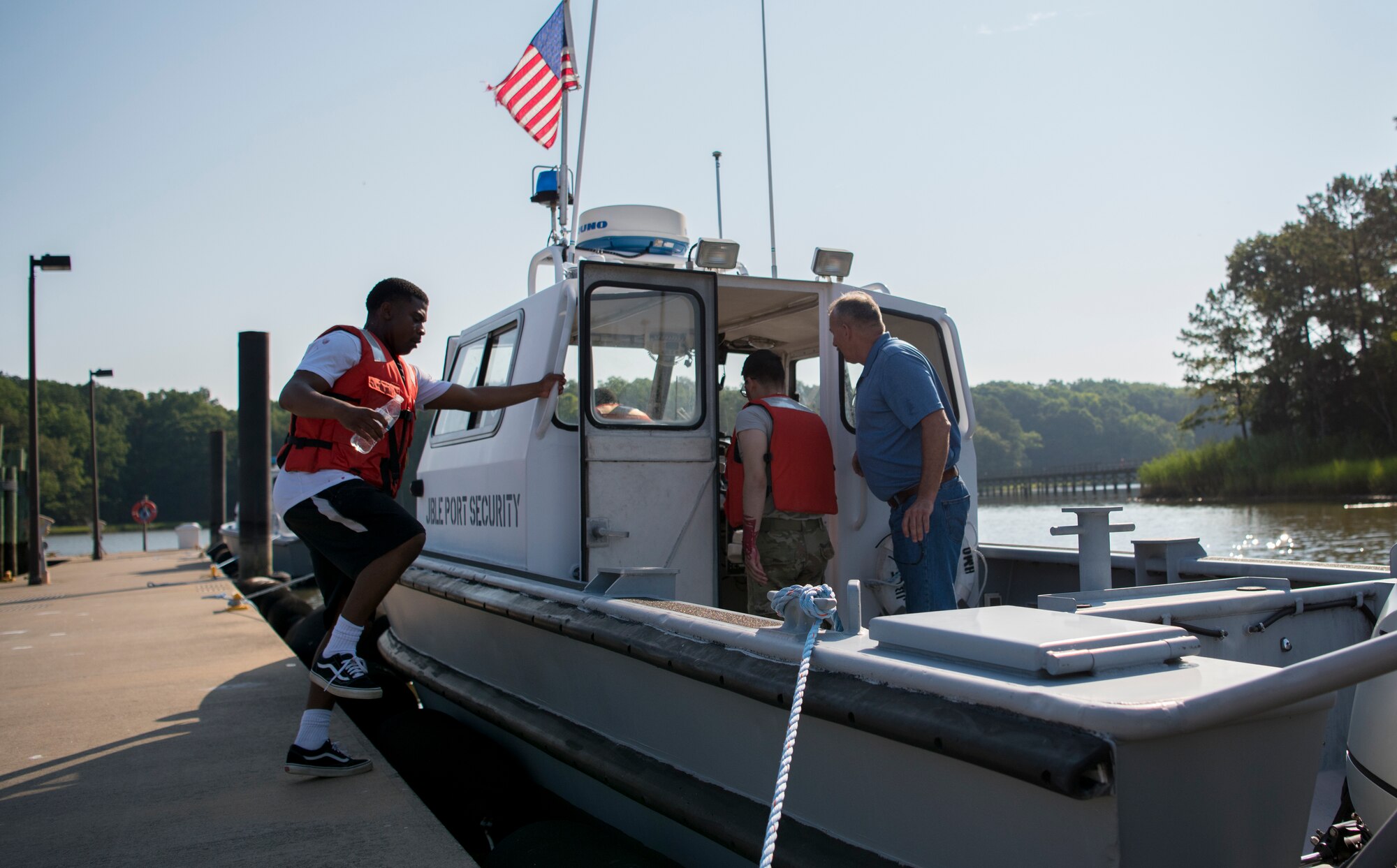 Volunteers board a boat prior to an aircraft crash exercise at Joint Base Langley-Eustis, Virginia, July 17, 2018.