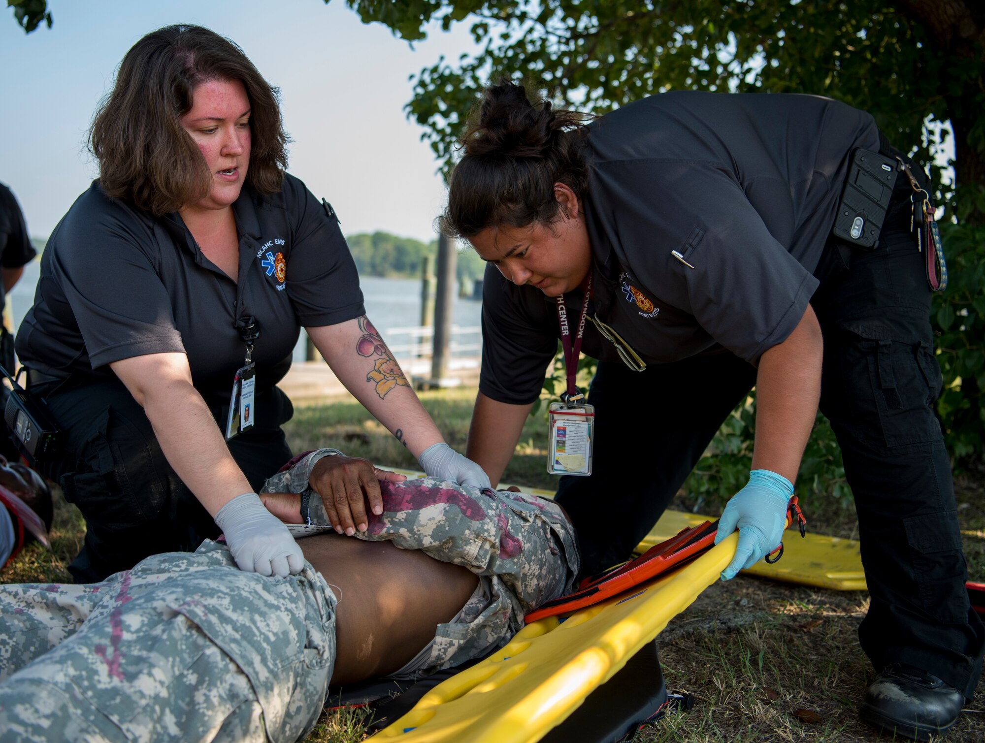 McDonald Army Health Center emergency services personnel work to secure a patient during an aircraft crash exercise at Joint Base Langley-Eustis, Virginia, July 17, 2018.