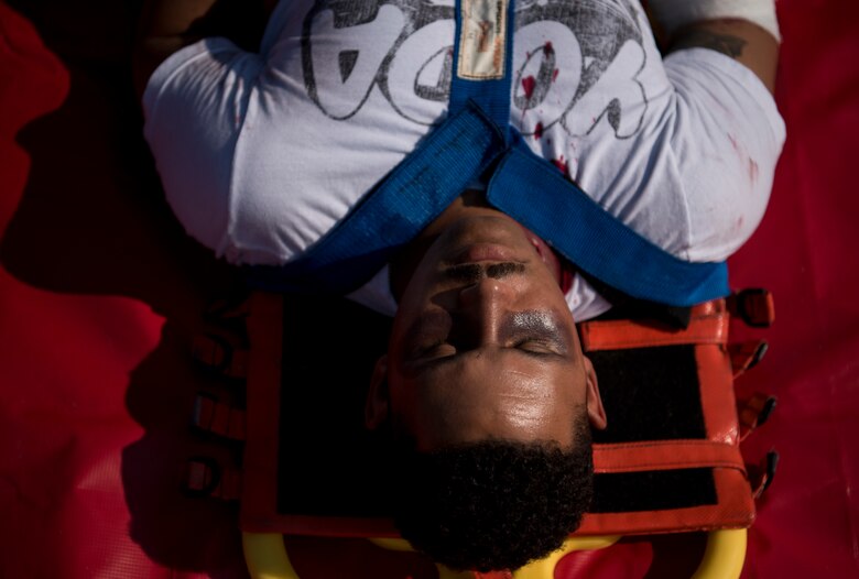 A patient waits for medical transportation during an aircraft crash exercise at Joint Base Langley-Eustis, Virginia, July 17, 2018.