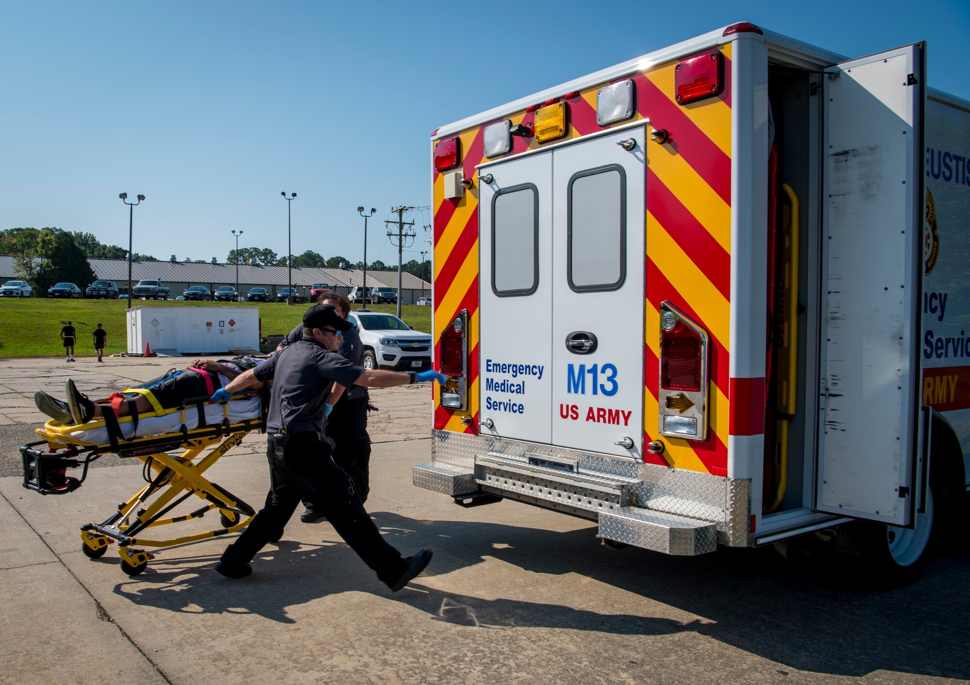 McDonald Army Health Center emergency services personnel prepare to load a patient onto an ambulance during an aircraft crash exercise at Joint Base Langley-Eustis, Virginia, July 17, 2018.