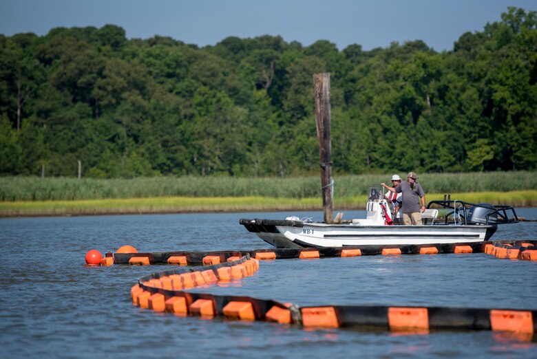 Emergency response personnel contain possible hazardous materials or oils that may have spilled during an aircraft crash exercise at Joint Base Langley-Eustis, Virginia, July 17, 2018.