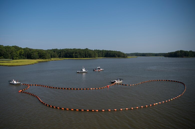 Emergency response personnel contain possible hazardous materials or oils that may have spilled during an aircraft crash exercise at Joint Base Langley-Eustis, Virginia, July 17, 2018.