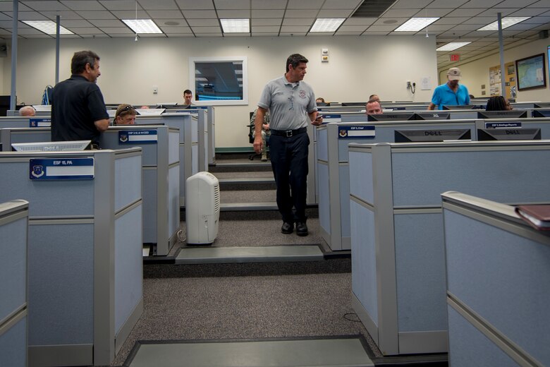 Members from various agencies across Joint Base Langley-Eustis, Virginia, gather at the Fort Eustis Emergency Operations Center during an aircraft crash exercise at JBLE, July 17, 2018.