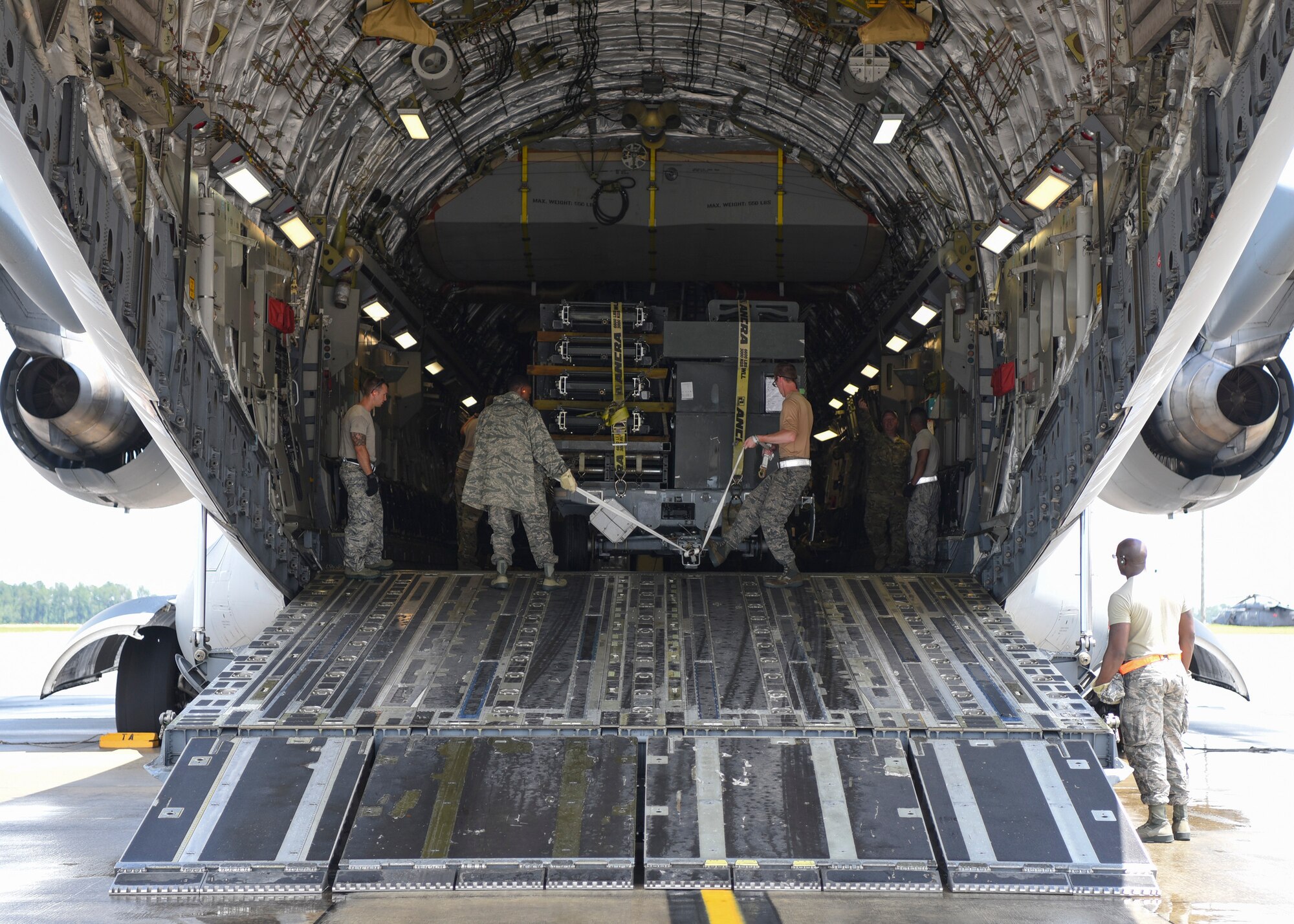 Airmen from the 23d Logistics Readiness Squadron load cargo into a C-17 Globemaster III, July 5, 2018, at Moody Air Force Base, Ga.  Airmen loaded approximately 68,000 pounds of cargo onto a C-17 to aid the 75th Fighter Squadron (FS) prior to a deployment. The 75th FS and supporting units recently deployed to an undisclosed location in support of Operation Spartan Shield. (U.S. Air Force photo by Airman Taryn Butler)