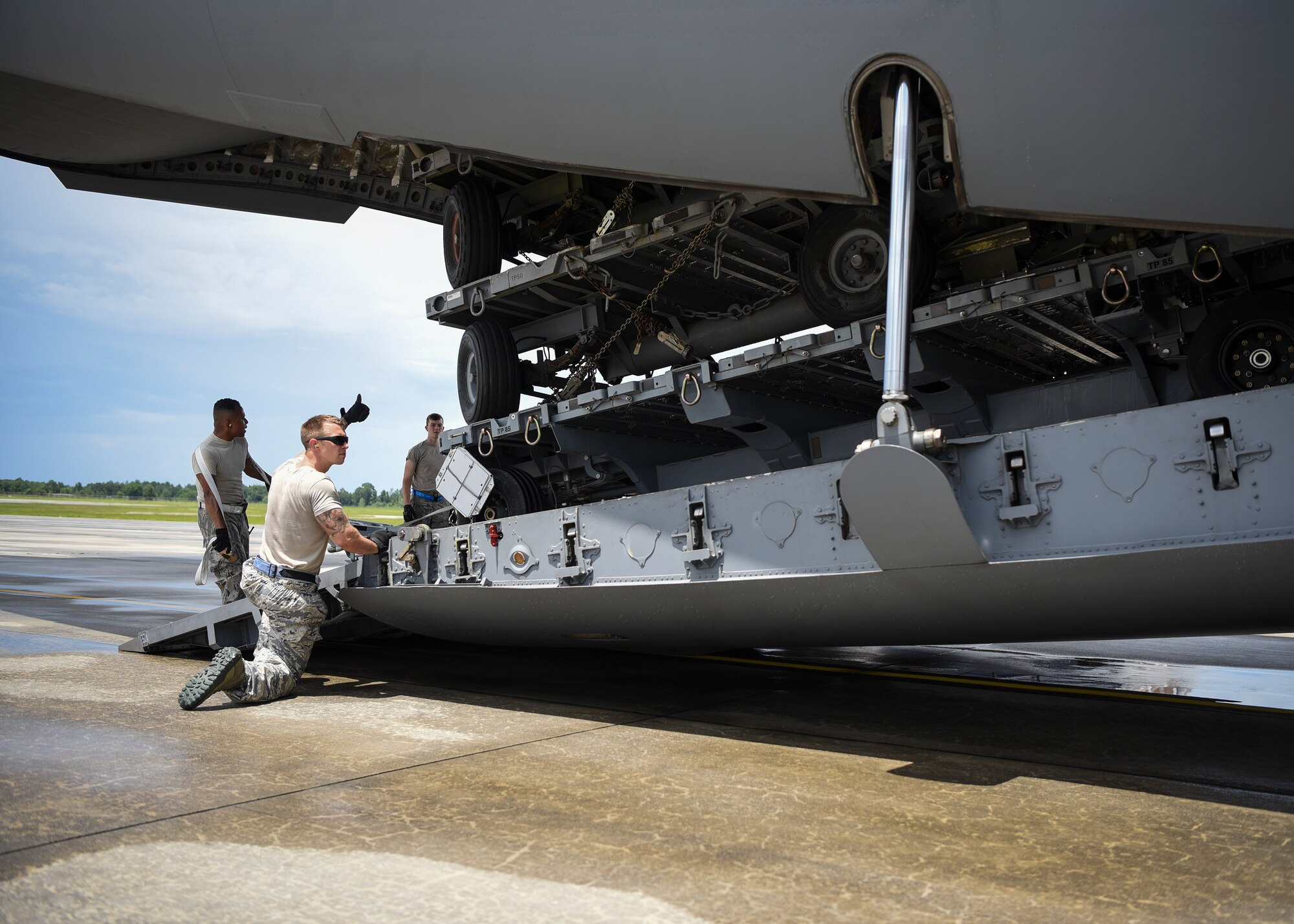 Staff Sgt. Mitchel Bordley, 23d Logistics Readiness Squadron air terminal operations supervisor, gives a thumbs-up to Airmen loading a C-17 Globemaster III, July 5, 2018, at Moody Air Force Base, Ga.  Airmen loaded approximately 68,000 pounds of cargo onto a C-17 to aid the 75th Fighter Squadron (FS) prior to a deployment. The 75th FS and supporting units recently deployed to an undisclosed location in support of Operation Spartan Shield. (U.S. Air Force photo by Airman Taryn Butler)
