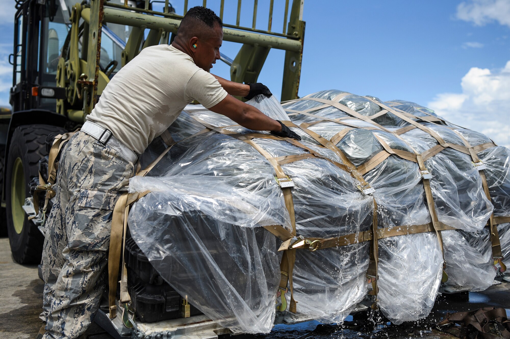 Staff Sgt. Mauricio Castaneda, 23d Logistics Readiness Squadron assistant NCO in charge of air terminal operations, drains water from cargo, July 5, 2018, at Moody Air Force Base, Ga.  Airmen loaded approximately 68,000 pounds of cargo onto a C-17 Globemaster III to aid the 75th Fighter Squadron (FS) prior to a deployment. The 75th FS and supporting units recently deployed to an undisclosed location in support of Operation Spartan Shield. (U.S. Air Force photo by Airman Taryn Butler)