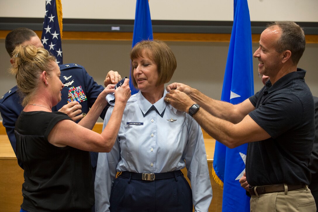 Melissa Swarbrick and Robert Smith place brigadier general rank insignia on their sister, Col. Michelle Hayworth, Air Forces Cyber vice commander, during her promotion ceremony at Joint Base San Antonio-Lackland, Texas, July, 16, 2018. In June, Hayworth re-joined AFCYBER from Air Force Space Command. She previously served in AFCYBER, most recently as the 688th Cyberspace Wing Commander. (U.S. Air Force photo by Tech. Sgt. R.J. Biermann)