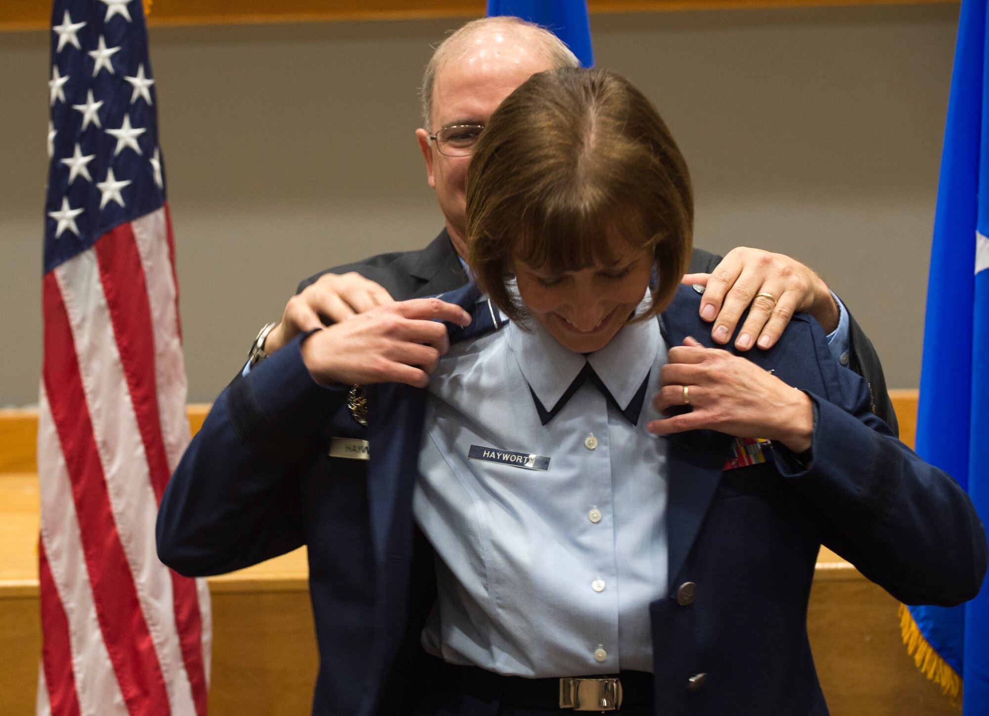 Stan Hayworth helps his wife, Brig. Gen. Michelle Hayworth, Air Forces Cyber vice commander, put on her service coat during her promotion ceremony at Joint Base San Antonio-Lackland, Texas, July, 16, 2018. In June, Michelle re-joined AFCYBER from Air Force Space Command. She previously served in AFCYBER, most recently as the 688th Cyberspace Wing Commander. (U.S. Air Force photo by Tech. Sgt. R.J. Biermann)