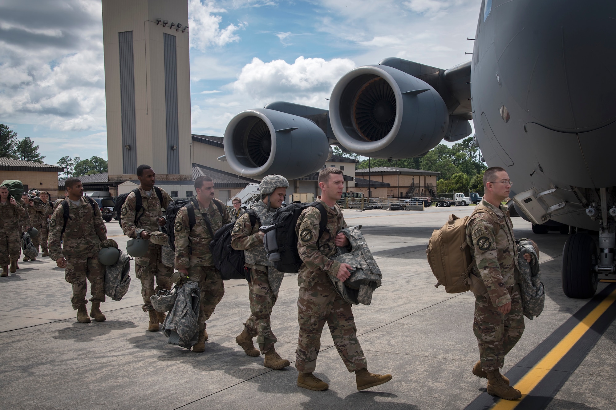 Moody Airmen prepare to board a C-17 Globemaster III prior to deploying, July 5, 2018, at Moody Air Force Base, Ga. Airmen from the 75th Fighter Squadron (FS) and supporting units recently deployed to an undisclosed location in support of Operation Spartan Shield. The 75th FS will undertake close air support missions with the A-10C Thunderbolt II while deployed. (U.S. Air Force photo by Airman 1st Class Eugene Oliver)