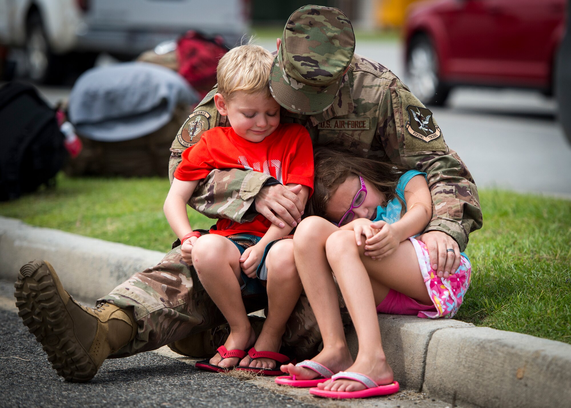 Tech. Sgt. Christopher West, 23d Aircraft Maintenance Squadron weapons expeditor, cradles his son, William and daughter Makayla, July 8, 2018, at Moody Air Force Base, Ga. Airmen from the 75th Fighter Squadron (FS) and supporting units deployed to an undisclosed location in support of Operation Spartan Shield. (U.S. Air Force photo by Staff Sgt. Ceaira Tinsley)