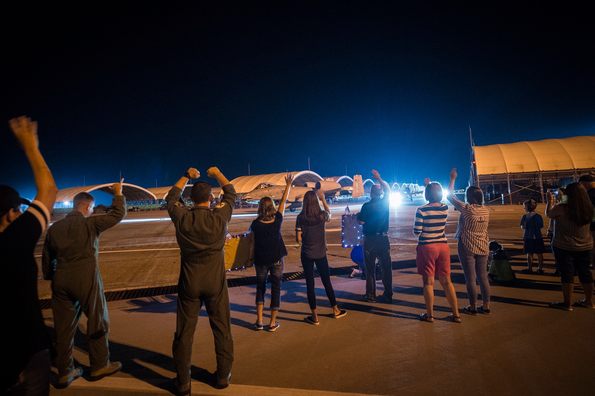 Airmen and families cheer on members of the 75th Fighter Squadron (FS) July 9, 2018, at Moody Air Force Base, Ga. Airmen from the 75th FS and supporting units deployed to an undisclosed location in support of Operation Spartan Shield. (U.S. Air Force photo by Staff Sgt. Ceaira Tinsley)