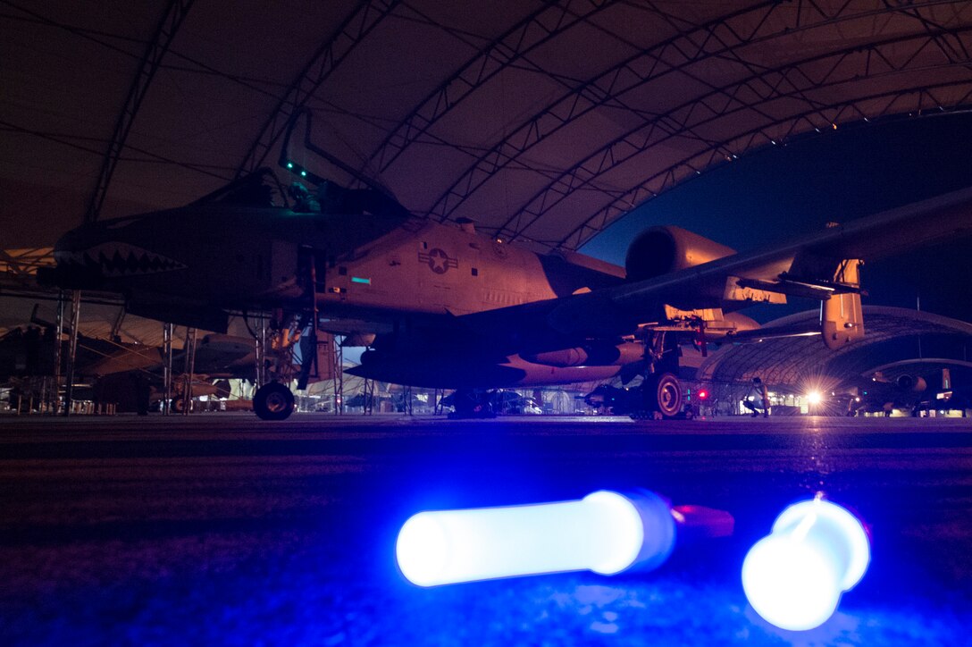 Glow sticks illuminate an A-10C Thunderbolt II July 9, 2018, at Moody Air Force Base, Ga. Airmen from the 75th Fighter Squadron (FS) and supporting units deployed to an undisclosed location in support of Operation Spartan Shield. (U.S. Air Force photo by Staff Sgt. Ceaira Tinsley)