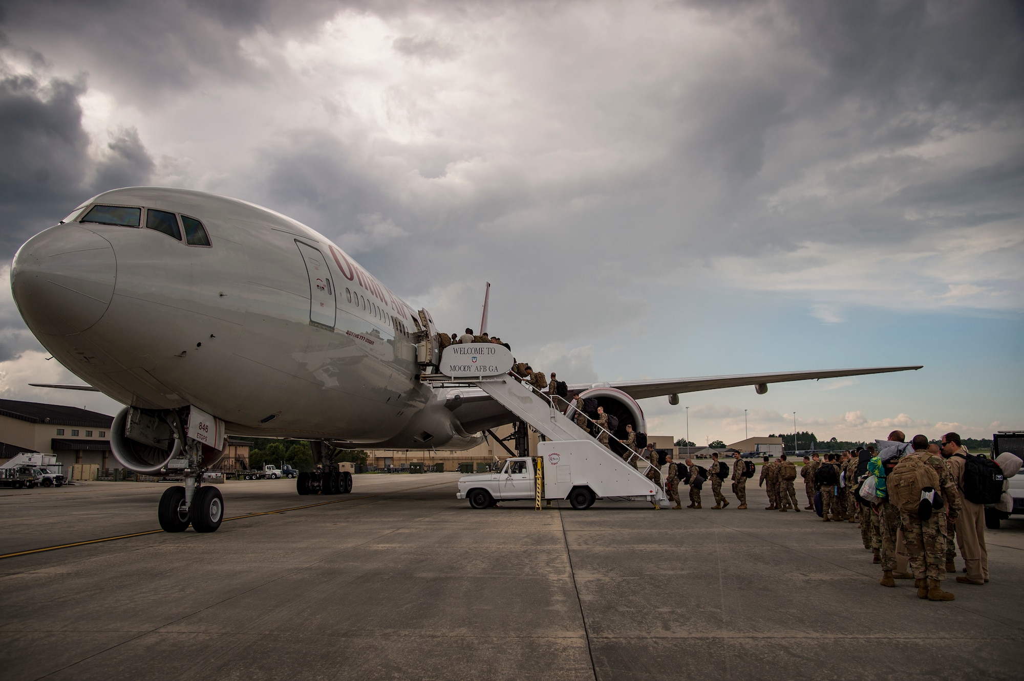 Airmen from the 75th Fighter Squadron (FS) and supporting units board a plane July 8, 2018, at Moody Air Force Base, Ga. The 75th FS and supporting units deployed to an undisclosed location in support of Operation Spartan Shield. (U.S. Air Force photo by Andrea Jenkins)