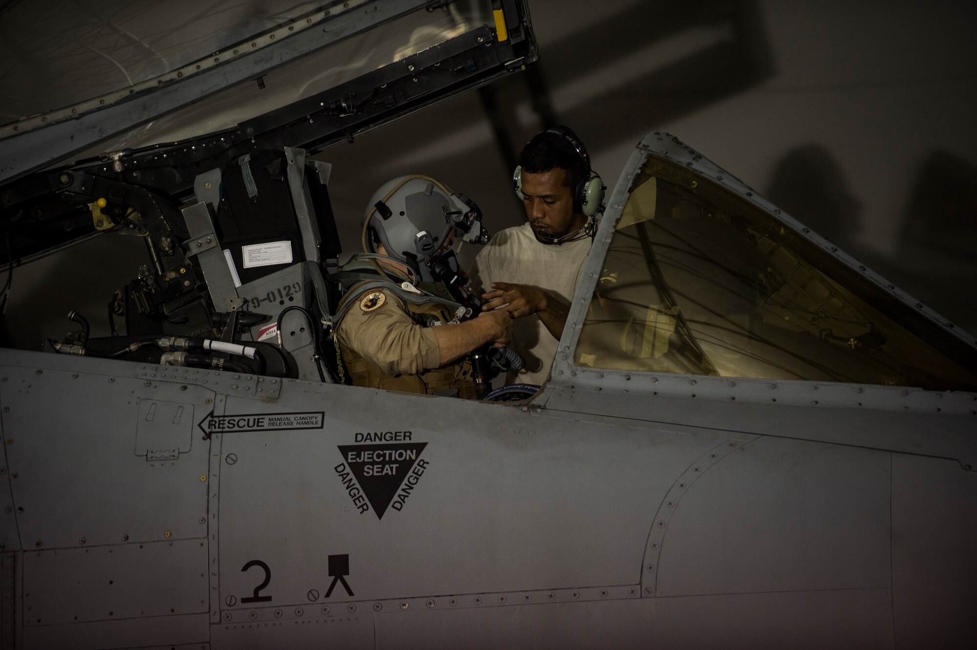 Senior Airman Daniel Ioane, 23d Aircraft Maintenance Squadron crew chief, assists an A-10C Thunderbolt II pilot with his harness, July 9, 2018, at Moody Air Force Base, Ga. Airmen from the 75th Fighter Squadron (FS) and supporting units deployed to an undisclosed location in support of Operation Spartan Shield. (U.S. Air Force photo by Andrea Jenkins)