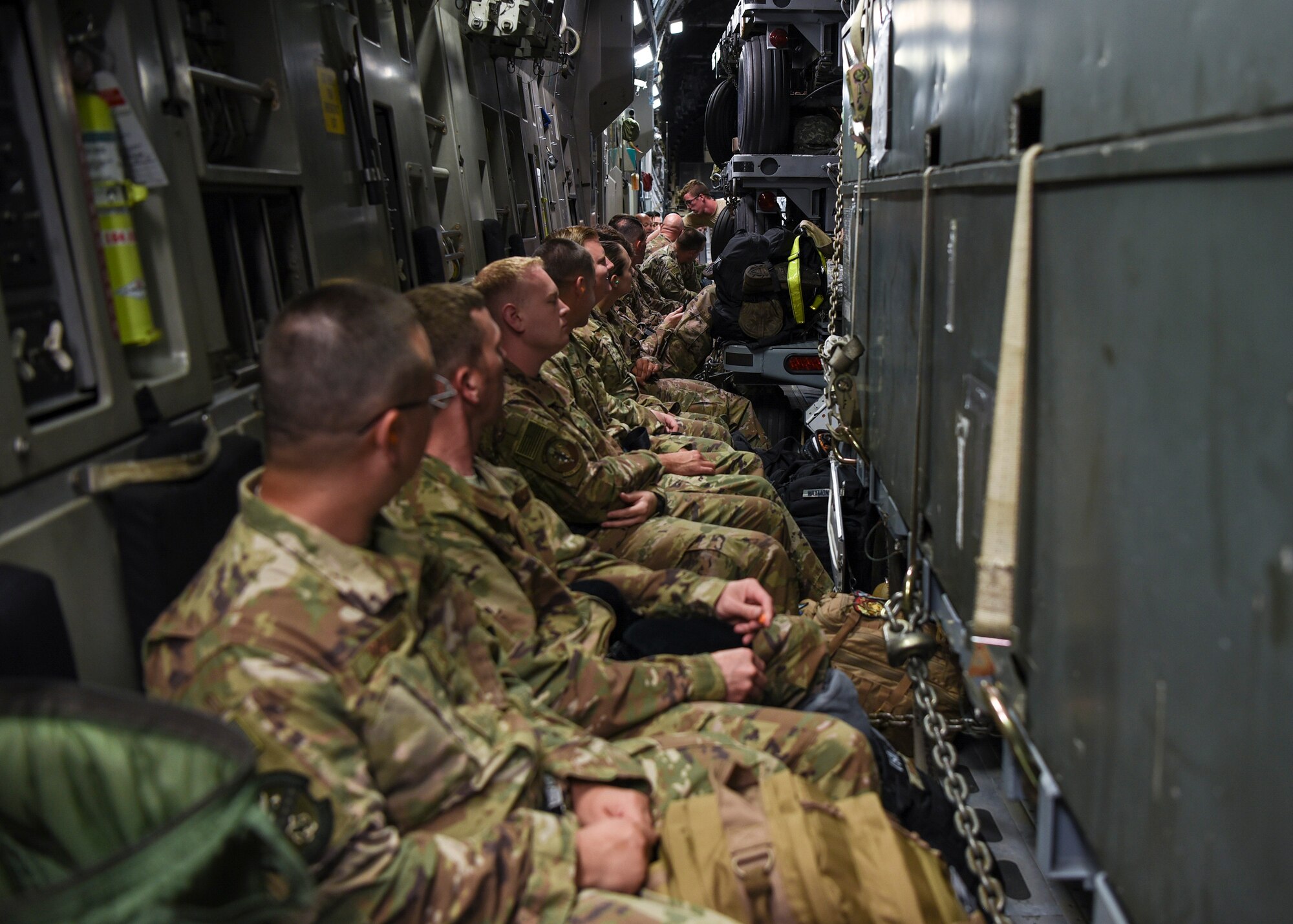 Airmen in support of the 75th Fighter Squadron (FS) wait in a C-17 Globemaster III, July 5, 2018, at Moody Air Force Base, Ga. The 75th FS and supporting units recently deployed to an undisclosed location in Southwest Asia. While deployed, the 75th FS will provide close air support missions through the A-10 Thunderbolt II, which is specifically designed for long loiter time, accurate weapons delivery, austere field capability and survivability. (U.S. Air Force photo by Airman Taryn Butler)