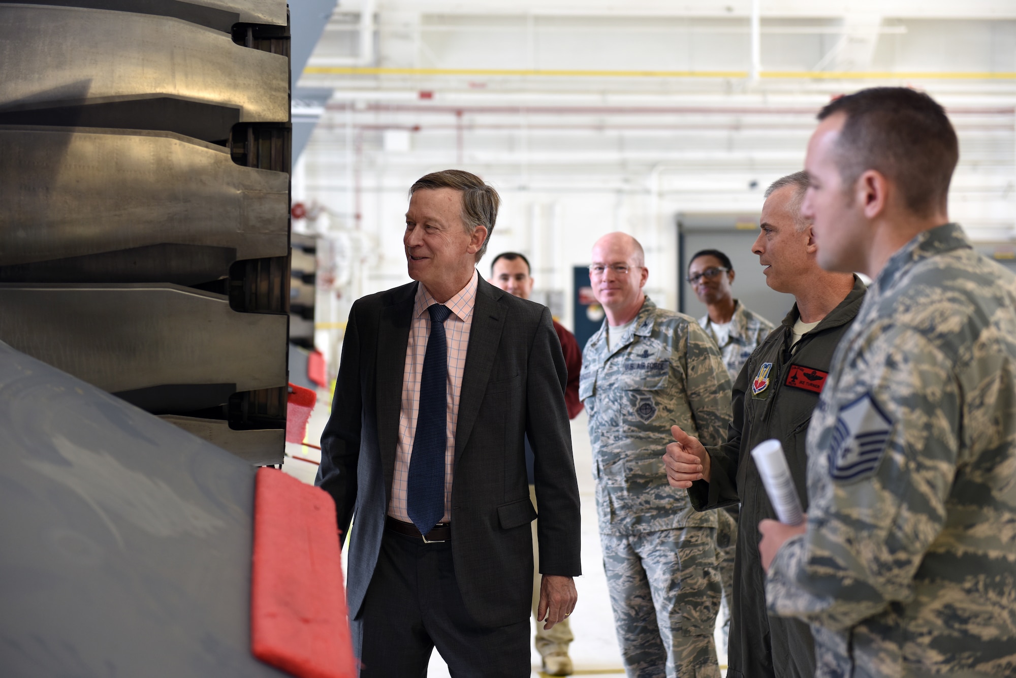 Gov. John Hickenlooper of Colorado, far left, receives a brief on the Colorado Air National Guard’s F-16 Falcon’s mission capabilities from Col. Brian Turner, second from right, 140th Wing commander, at Buckley Air Force Base, Colorado, July 17, 2018.