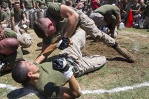 Lance Cpl. Cory Helton, top, a power lines mechanic with Marine Fighter Attack Squadron 232 and Whitley County, Ky., native, grapples with another Marine during the Kings and Queens of the Ring event at the first Marine Aircraft Group 11 field meet aboard Marine Corps Air Station Miramar, Calif., Aug. 22. Marines throughout MAG-11 competed in different events to win the MAG-11 trophy for their squadron.