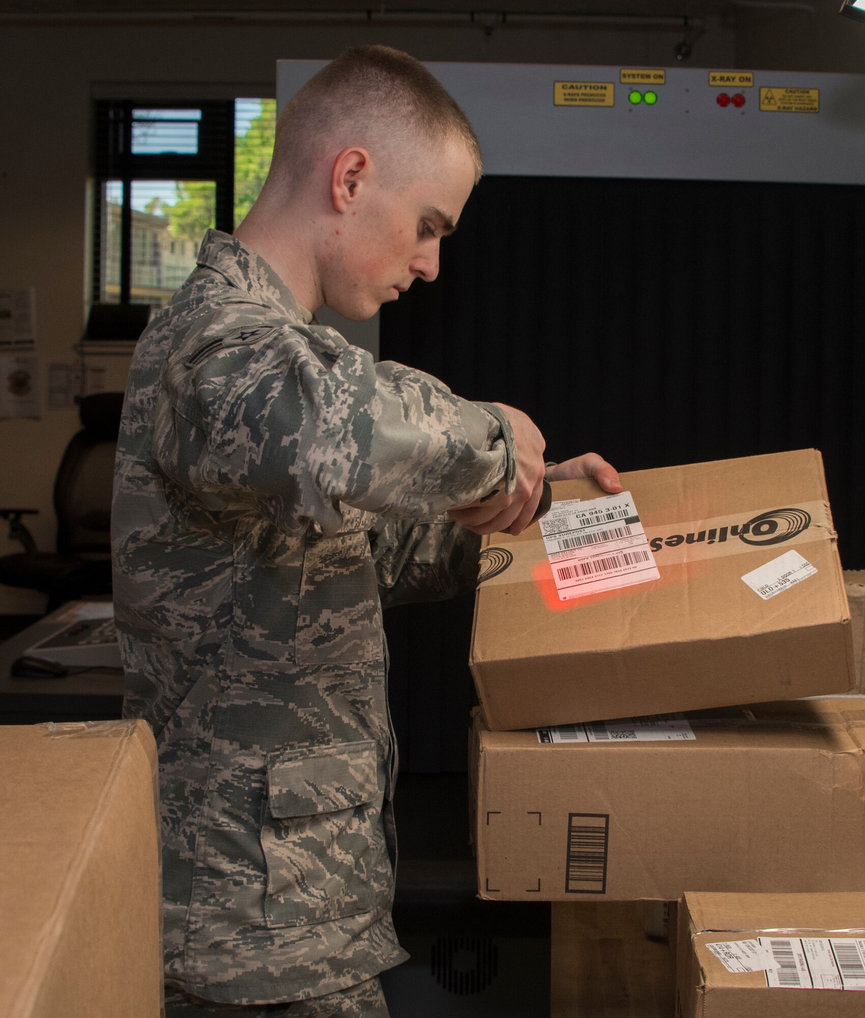 Airman 1st Class Noah Carlton, 60th Force Support Squadron, scans a label on a parcel, May 5, 2018, Travis Air Force Base, Calif. The 60 FSS Official Mail Center is responsible for processing mail for Travis AFB, David Grant USAF Medical Center, and commercial company deliveries. (U.S. Air Force Photo by Heide Couch)