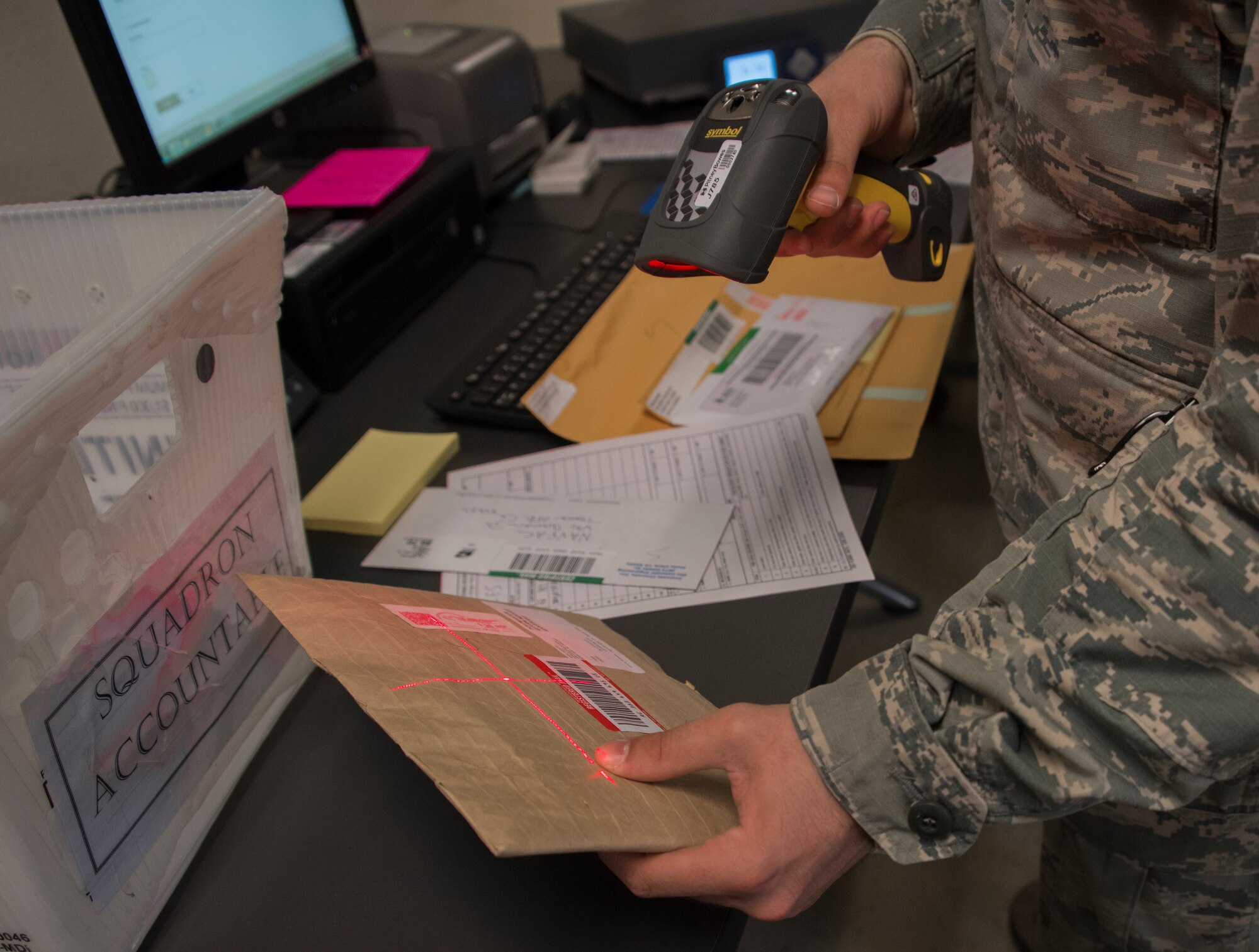 Airman 1st Class Noah Carlton, 60th Force Support Squadron, scans a label on a parcel, May 5, 2018, Travis Air Force Base, Calif. The 60 FSS Official Mail Center is responsible for processing mail for Travis AFB, David Grant USAF Medical Center, and commercial company deliveries. (U.S. Air Force Photo by Heide Couch)