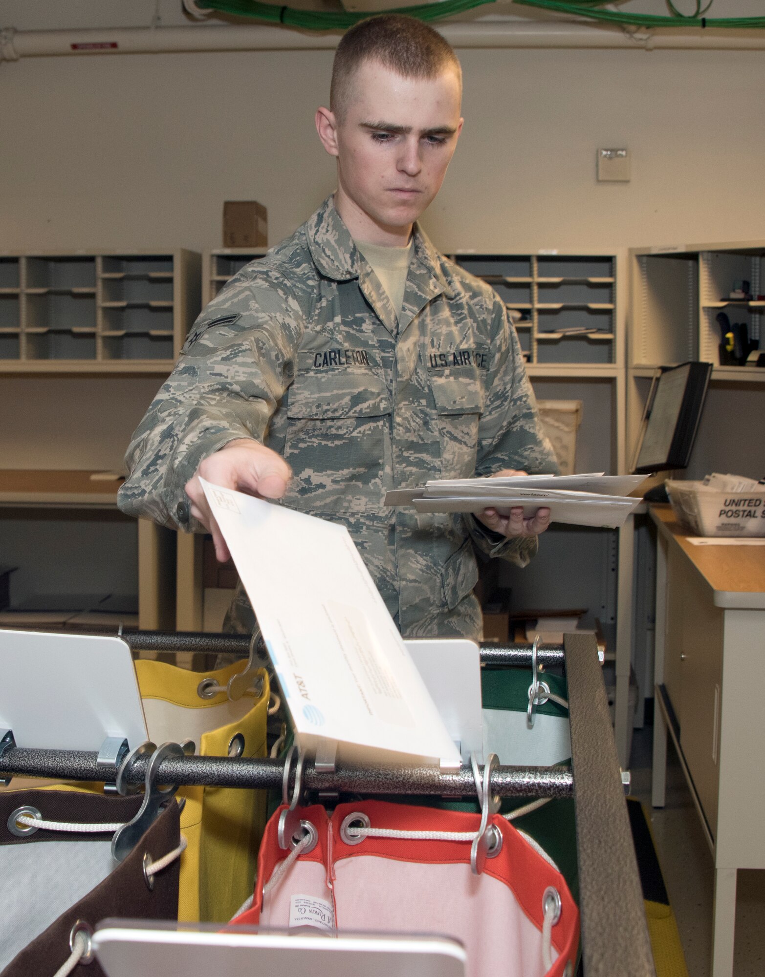 Airman 1st Class Noah Carlton, 60th Force Support Squadron, sorts the day’s squadron mail, May 5, 2018, Travis Air Force Base, Calif. The 60 FSS Official Mail Center is responsible for processing mail for Travis AFB, David Grant USAF Medical Center, and commercial company deliveries.  (U.S. Air Force Photo by Heide Couch)