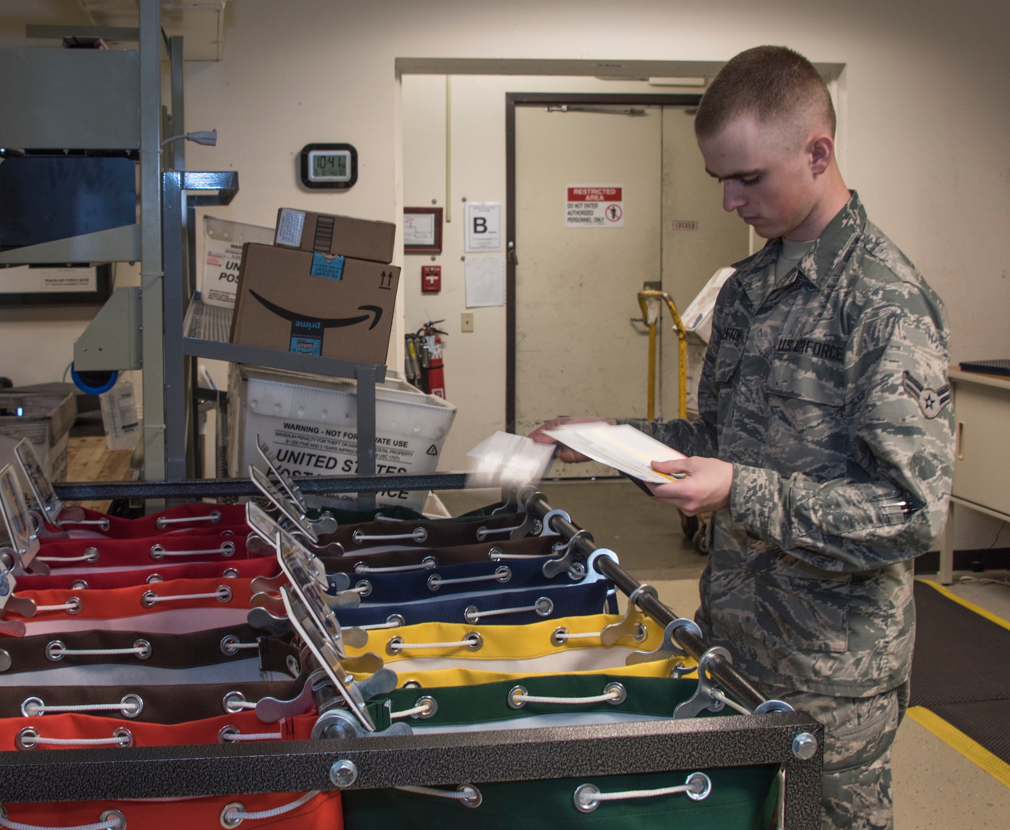 Airman 1st Class Noah Carlton, 60th Force Support Squadron, sorts the day’s squadron mail, May 5, 2018, Travis Air Force Base, Calif. The 60 FSS Official Mail Center is responsible for processing mail for Travis AFB, David Grant USAF Medical Center, and commercial company deliveries.  (U.S. Air Force Photo by Heide Couch)
