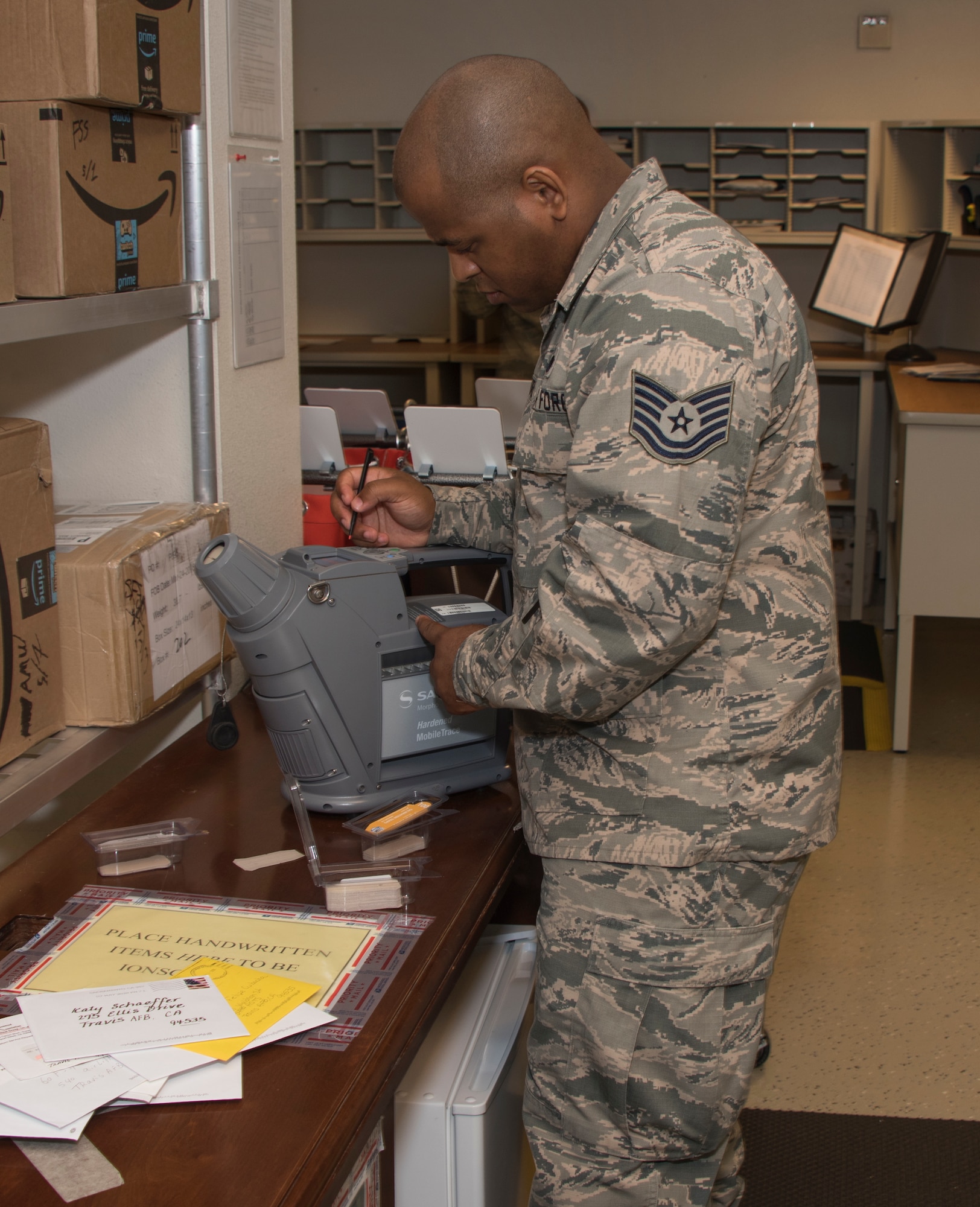 Tech. Sgt. Demarcus Pettiford, 60th Force Support Squadron, calibrates a MobieTrace Detection System. This device is used to detect fine traces of 10 different types of explosives.  The 60 FSS Official Mail Center is responsible for processing mail for Travis AFB, David Grant USAF Medical Center, and commercial company deliveries. (U.S. Air Force Photo by Heide Couch)