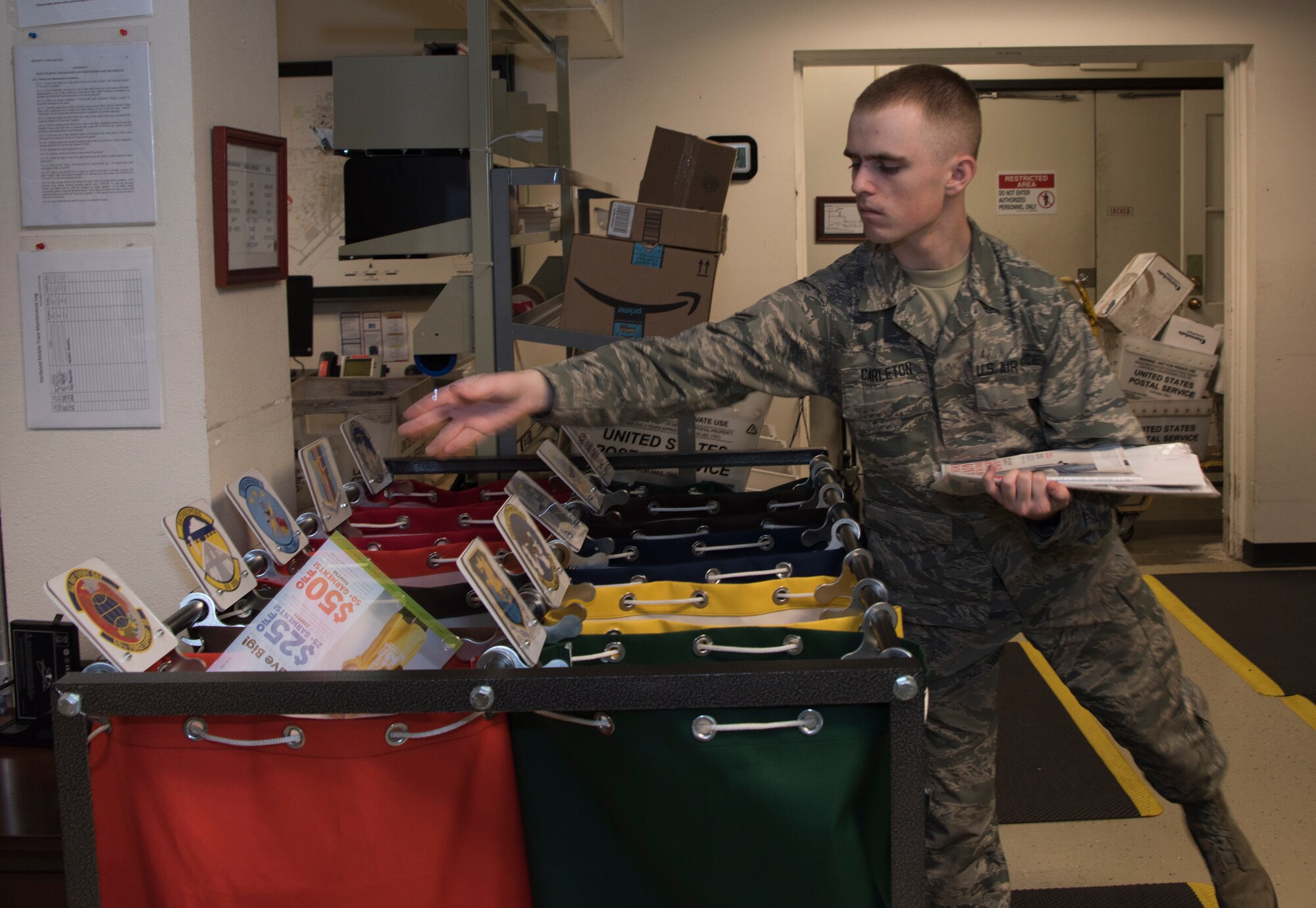 Airman 1st Class Noah Carlton, 60th Force Support Squadron, sorts the day’s squadron mail, May 5, 2018, Travis Air Force Base, Calif. The 60 FSS Official Mail Center is responsible for processing mail for Travis AFB, David Grant USAF Medical Center, and commercial company deliveries.  (U.S. Air Force Photo by Heide Couch)