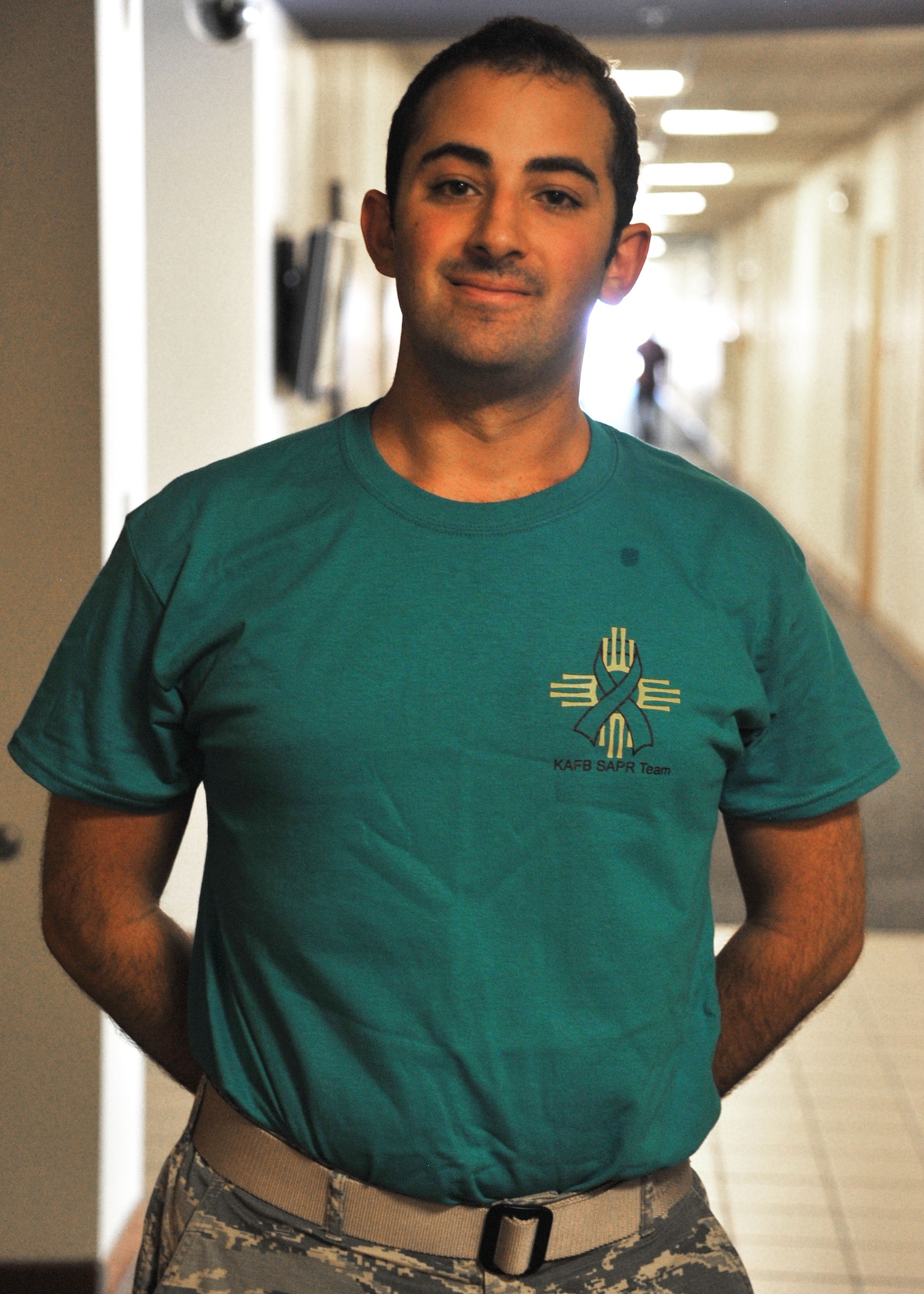 2nd Lt. Jacob Masin, a volunteer victim advocate for the Kirtland Sexual Assault Response Prevention office, displays his new teal morale shirt July 18 here. The new teal tees are approved for wear on Fridays to help people identify the victim advocates, and the opportunity to confidentially share a possible sexual assault or ask questions in a confidential manner. (U.S. Air Force photo by Jim Fisher)