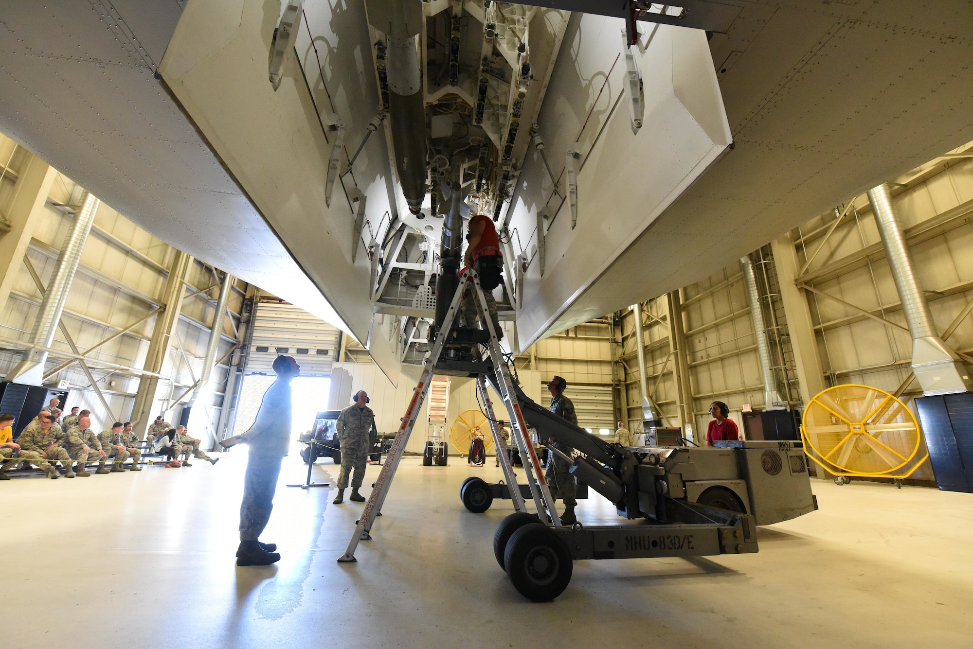 Weapons loaders from the 34th Aircraft Maintenance Unit load inert GBU-54 bombs onto a simulated B-1 Bomber during a load competition at Ellsworth Air Force Base, S.D., July 13, 2018. These competitions test to see which AMU can load bombs onto a simulated B-1 Bomber the fastest. (U.S Air Force photo by Airman 1st Class Thomas Karol)