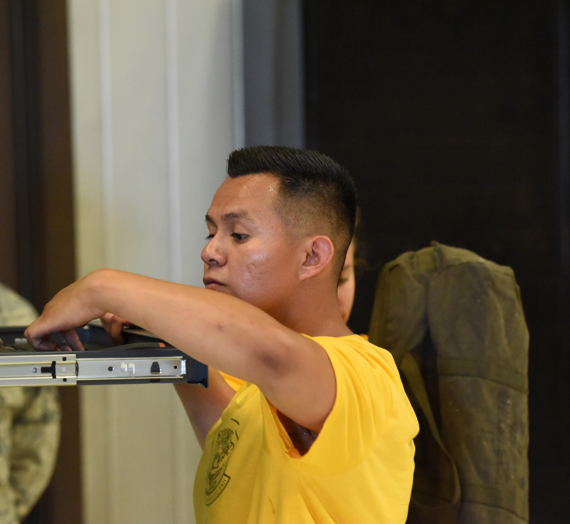 Airman 1st Class Christian Garcia, a 37th Aircraft Maintenance Unit weapons loader, looks for a wrench in a toolbox during a load competition at Ellsworth Air Force Base, S.D., July 13, 2018. Participants were judged on their uniforms, the condition of their tools, the time it took to load the bombs on the aircraft and how safely they performed their tasks. (U.S Air Force photo by Airman 1st Class Thomas Karol)