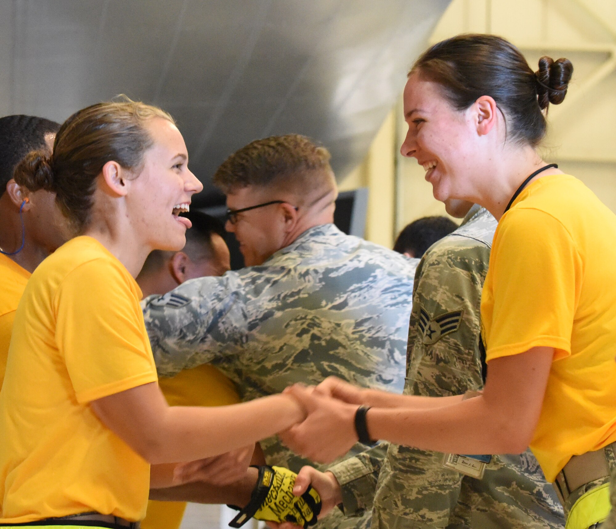 Airman 1st Class Candice Strickland, a 37th Aircraft Maintenance Unit weapons loader, shakes hands with members of her squadron after a load competition at Ellsworth Air Force Base, S.D., July 13, 2018. The 37th AMU won the competition with a time of 21 minutes and 35 seconds, approximately three minutes faster than the 34th AMU. (U.S Air Force photo by Airman 1st Class Thomas Karol)