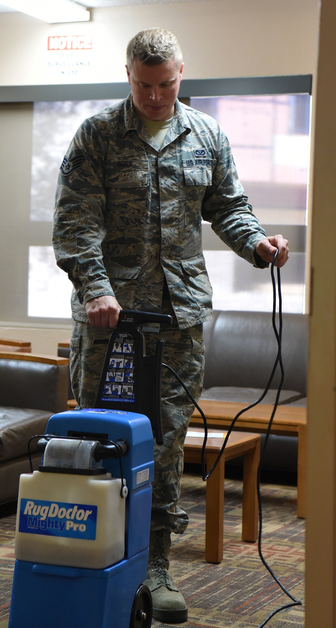 Staff Sgt. Jason Goss, an Airman dorm leader, uses a rug cleaner at Ellsworth Air Force Base, S.D., July 16, 2018. Dorm leaders ensure all six base dorms are maintained and kept in working order. (U.S. Air Force photo by Airman 1st Class Thomas Karol)