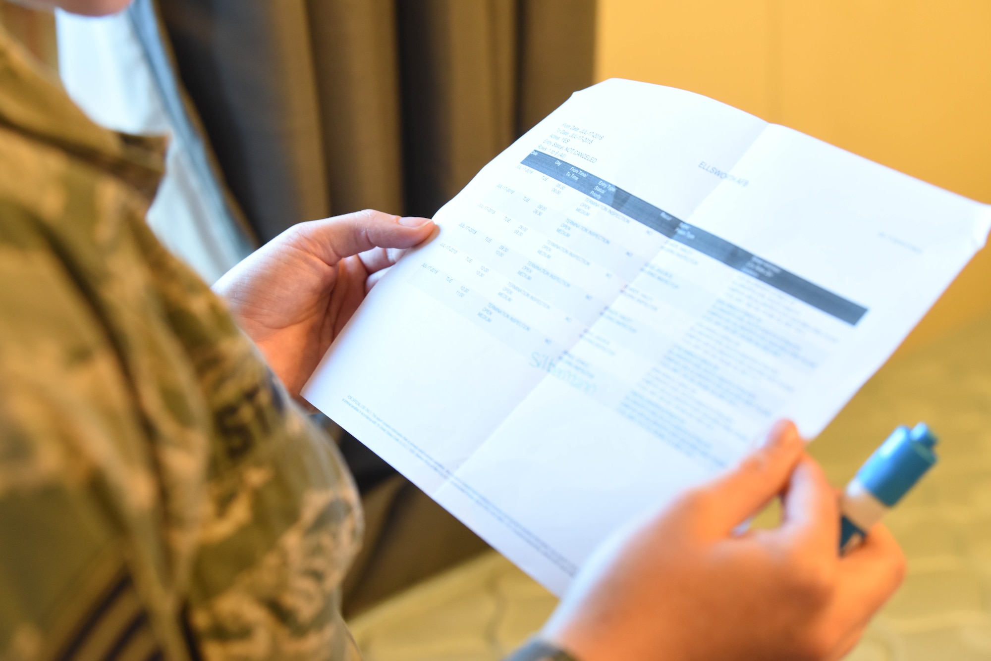 Staff Sgt. Hailey Staker, an Airman dorm leader, looks at a checklist at Ellsworth Air Force Base, S.D., July 17, 2018. Dorm leaders check if Airmen have completed all of their necessary paperwork and cleaned their dorm rooms so new residents can move in. (U.S. Air Force photo by Airman 1st Class Thomas Karol)