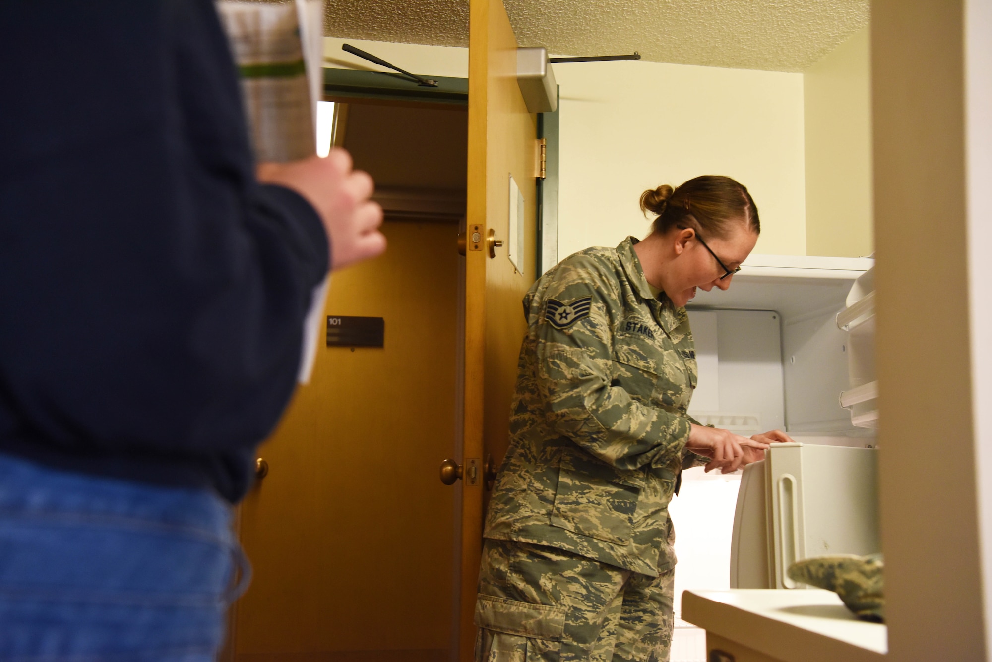 Staff Sgt. Hailey Staker, an Airman dorm leader, inspects the refrigerator of Airman 1st Class Casi Smith, a 28th Security Forces response force leader, at Ellsworth Air Force Base, S.D., July 17, 2018. Dorm leaders check every part of dorm rooms for Airmen out-processing for potential health and safety hazards. (U.S. Air Force photo by Airman 1st Class Thomas Karol)