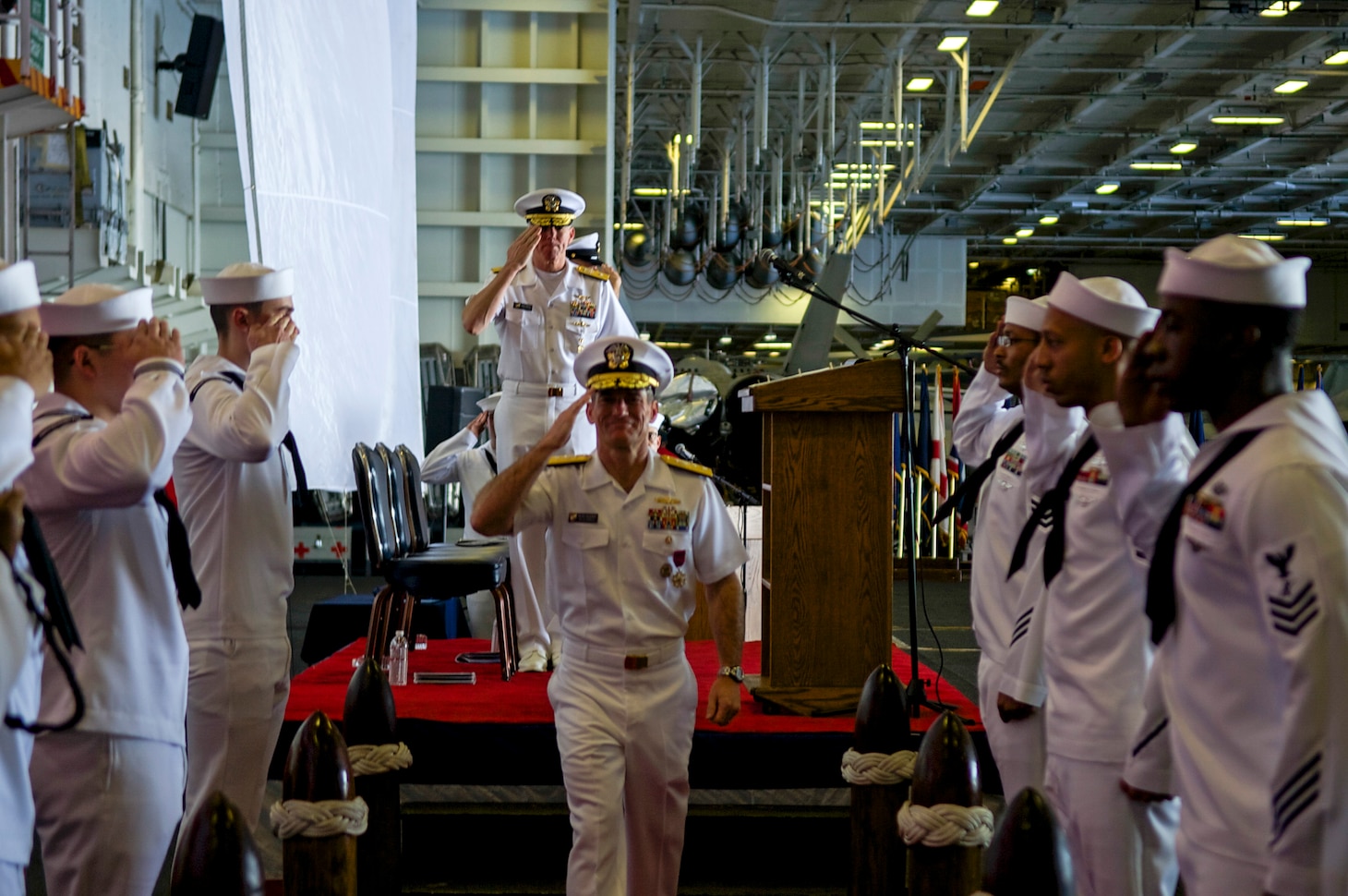 PHILIPPINE SEA (July 18, 2018) Rear Adm. Marc Dalton departs during the Commander, Task Force 70 change of command ceremony in the hangar bay aboard the aircraft carrier USS Ronald Reagan (CVN 76). Rear Adm. Karl O. Thomas relieved Dalton as commander, CTF 70. CTF 70 is forward-deployed to the U.S. 7th Fleet area of operations in support of security and stability in the Indo-Pacific region.