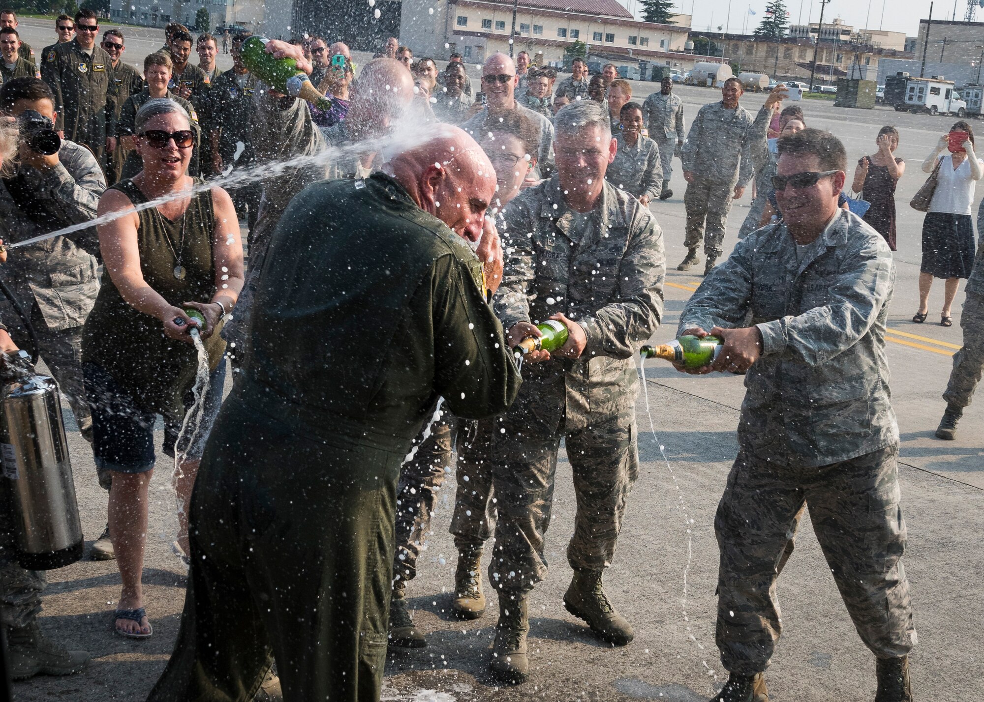 Col. Kenneth Moss, 374th Airlift Wing commander, is sprayed with champagne and water