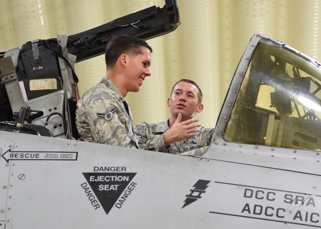 Master Sgt. Jacob Komenda, 51st Aircraft Maintenance squadron specialist section chief, explains Airman 1st Class Zachary Smith, 51st Medical Support squadron commander’s support section technician, the functions of various buttons in cockpit of a Fairchild Republic A-10 Thunderbolt II at Osan Air Base, Republic of Korea, July 18, 2018. As part of the Airman exchange, Airmen shadow members of the exchange unit and learn about some duties and abilities of its career field. (U.S. Air Force photo by Airman 1st Class Ilyana A. Escalona)