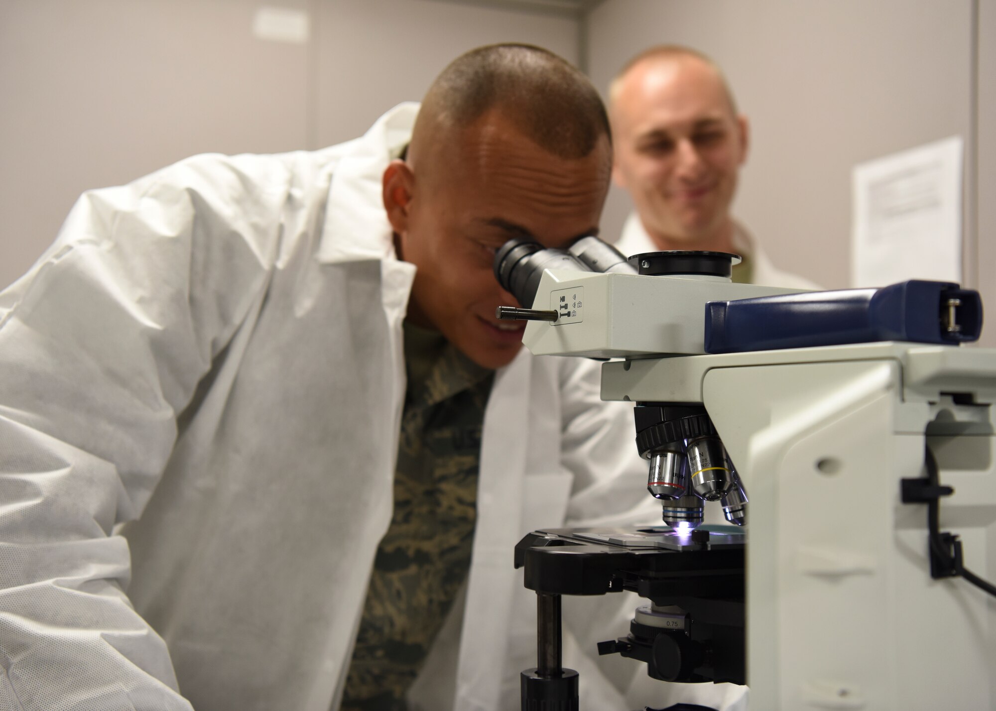 Staff Sgt. Nikita Canalin, 51st Aircraft Maintenance Squadron avionics system technician, examines blood samples in a lab at Osan Air Base, Republic of Korea, July 9, 2018. Throughout the day, Canalin was able to shadow medical technicians and understand why precision is key in performing medical duties. (U.S. Air Force photo by Airman 1st Class Ilyana A. Escalona)
