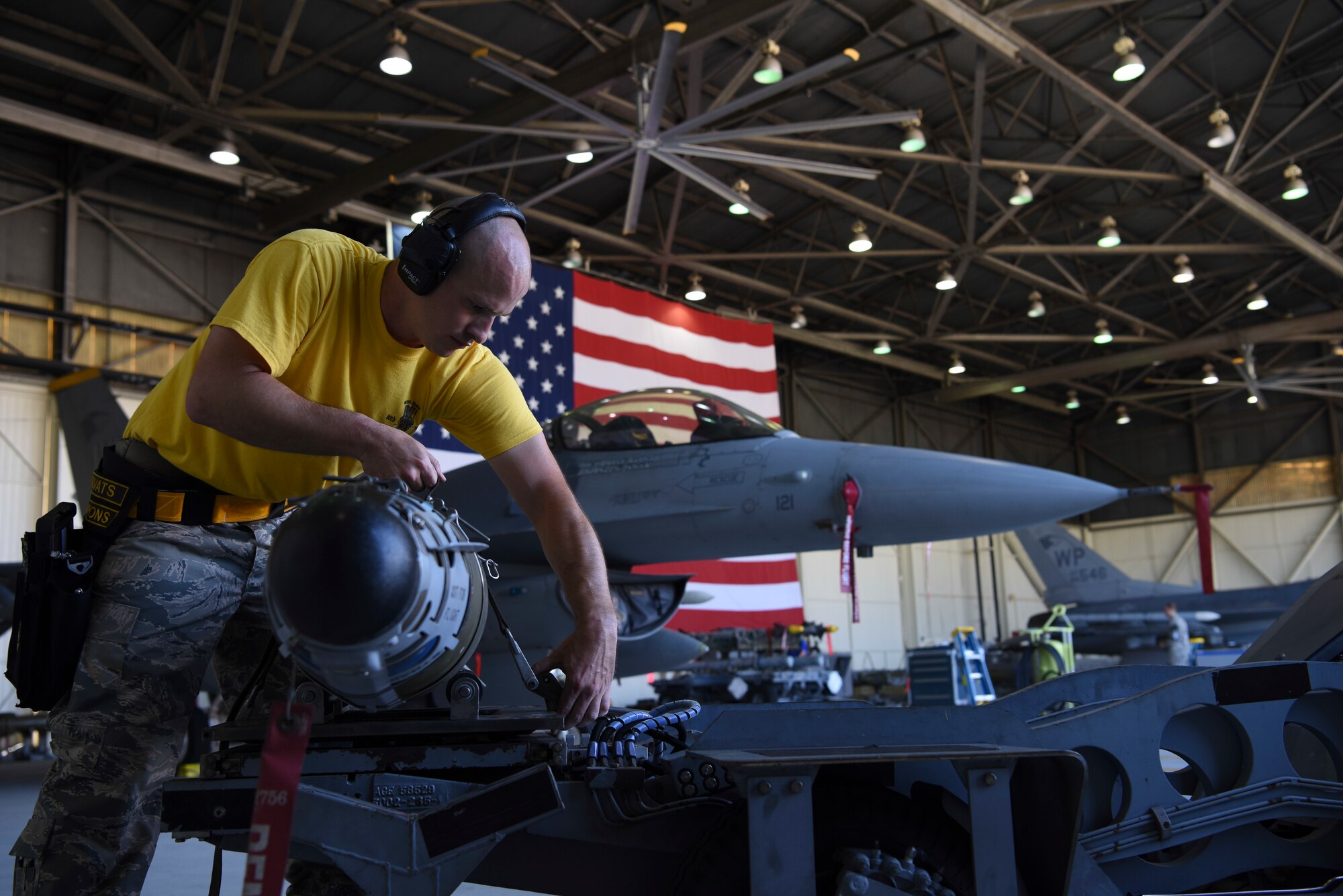U.S. Air Force Staff Sgt. Bryan Everidge, 80th Aircraft Maintenance Unit weapons load crew chief, straps down a GBU-54 joint direct attack munition bomb onto a bomb lift truck during the 8th Maintenance Group's 2nd Quarter Weapons Loading Competition at Kunsan Air Base, Republic of Korea, July 13, 2018. Two teams raced to load training weapons on their aircraft as fast as they could while trying to minimize discrepancies.