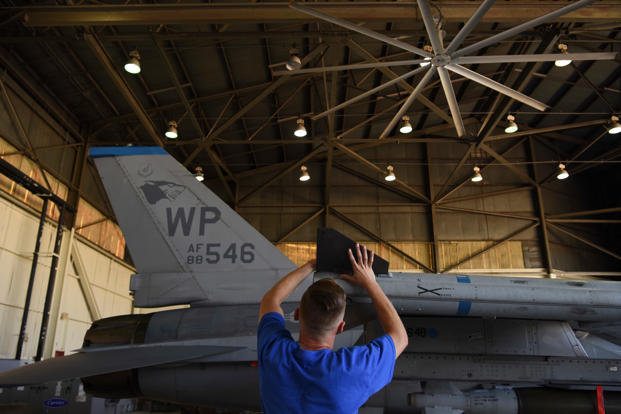 U.S. Air Force Senior Airman Matthew Rischard, 35th Aircraft Maintenance Unit weapons load crew member, secures wings for the AIM-120 missile on an F-16 Fighting Falcon during the 8th Maintenance Group's 2nd Quarter Weapons Loading Competition at Kunsan Air Base, Republic of Korea, July 13, 2018. Two teams raced to load training weapons on their aircraft as fast as they could while trying to minimize discrepancies.