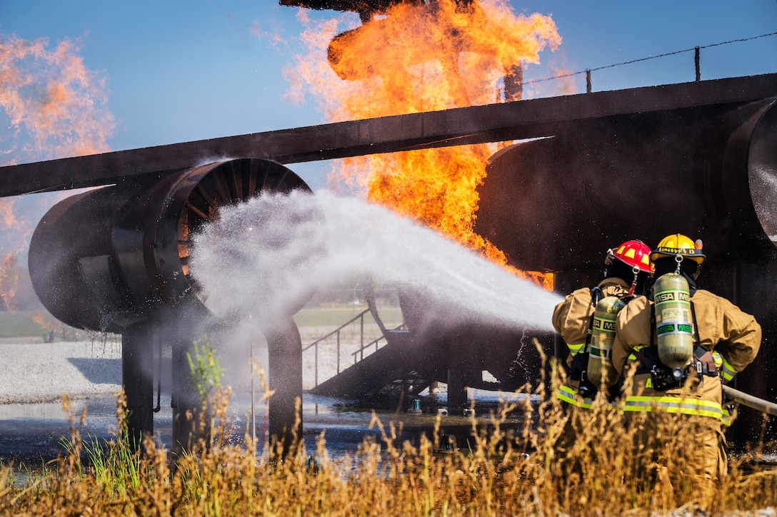 Firefighters undergo a simulated aircraft fire exercise.