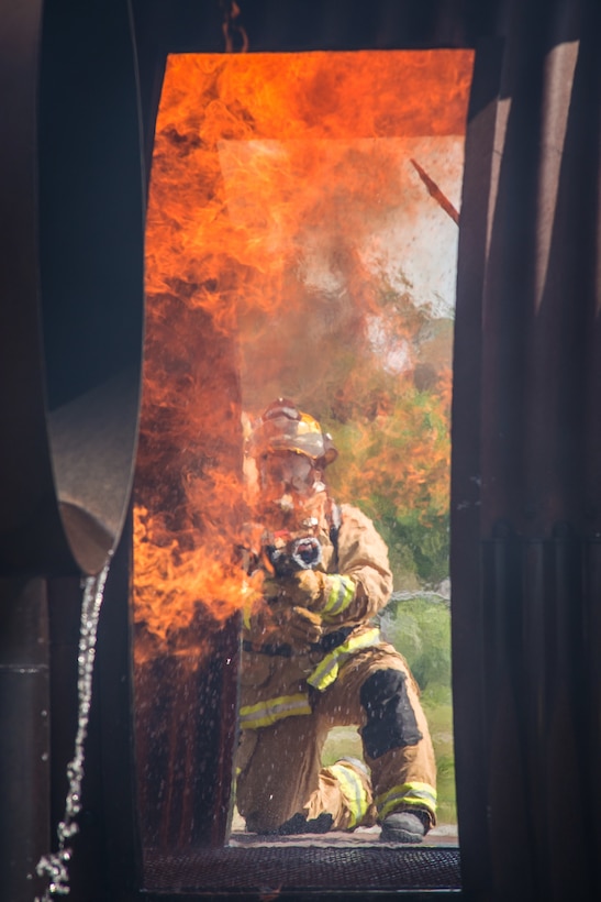 Firefighters conduct an aircraft live-fire exercise.