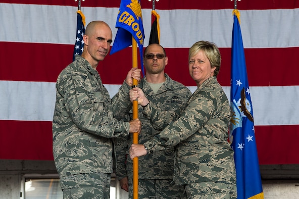 U.S. Air Force Col. Jason E. Bailey, 52nd Fighter Wing commander, left, passes the ceremonial guidon to Col. Marlyce K. Roth, incoming 52nd Mission Support Group commander, during the 52nd MSG change of command ceremony in Hangar 1 at Spangdahlem Air Base, Germany, July 19, 2018. (U.S. Air Force photo by Airman 1st Class Valerie Seelye)
