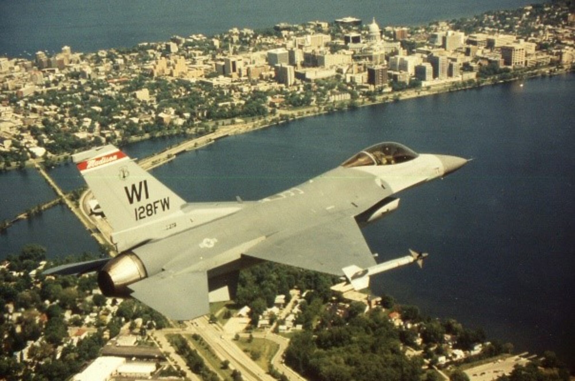 An F-16 Fighting Falcon assigned to the 115th Fighter Wing flies over Lake Monona in Madison Wis.